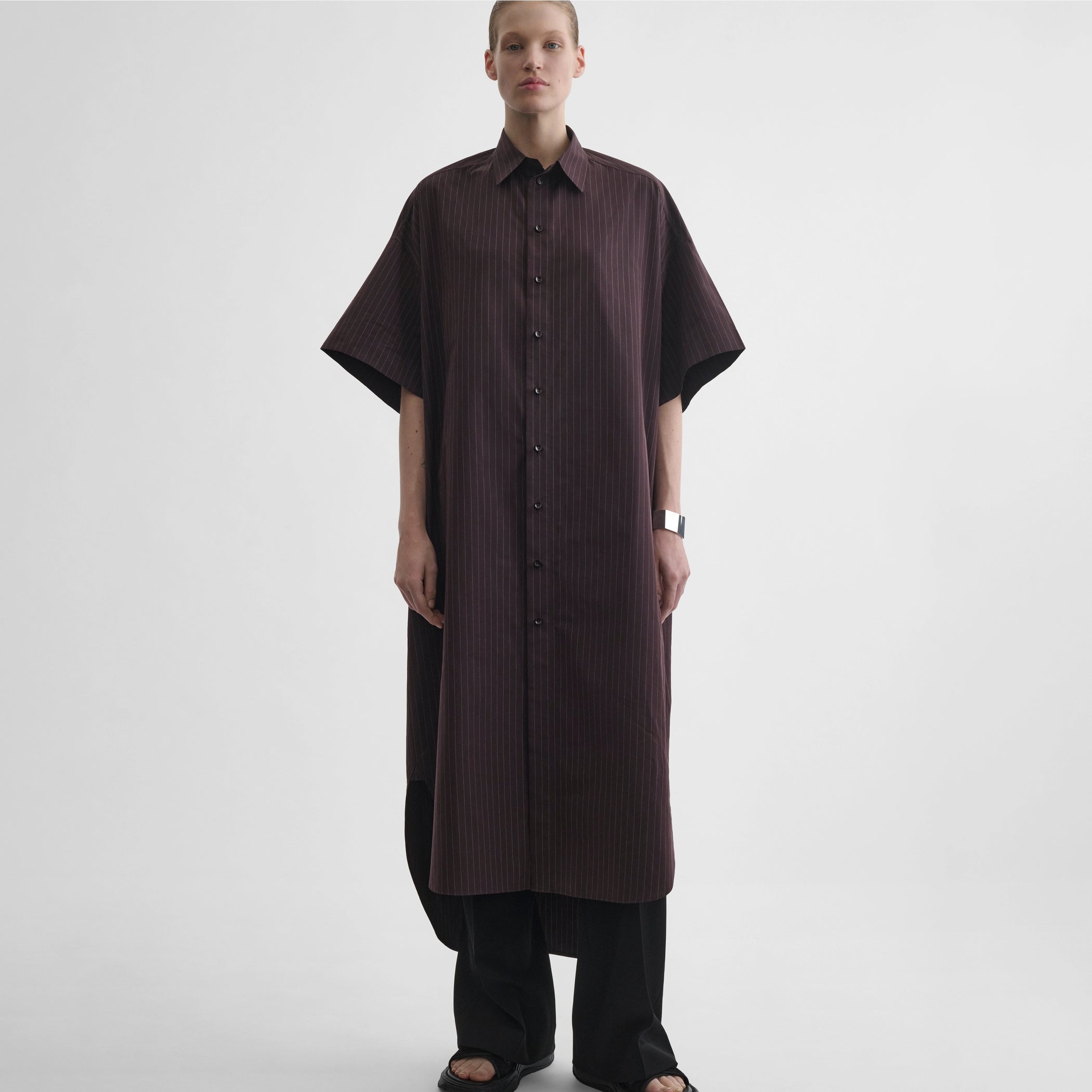 Front full body view of model wearing long shirt dress in black cherry cotton