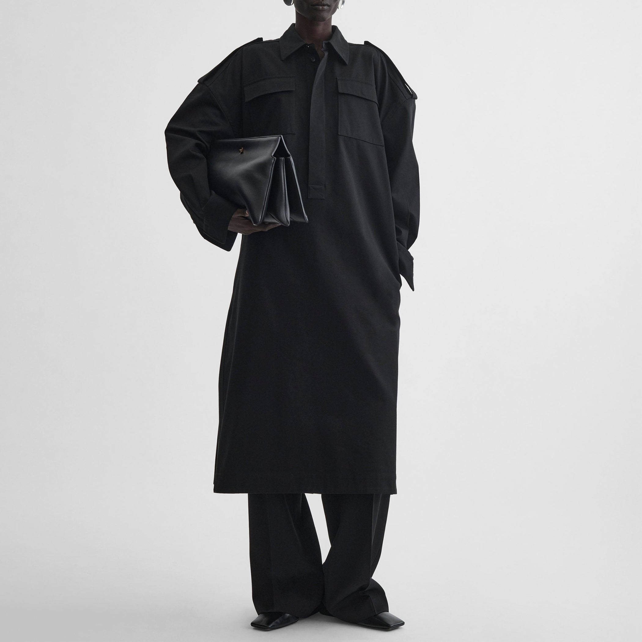 Front view of model wearing UTILITY SHIRT DRESS in black cotton