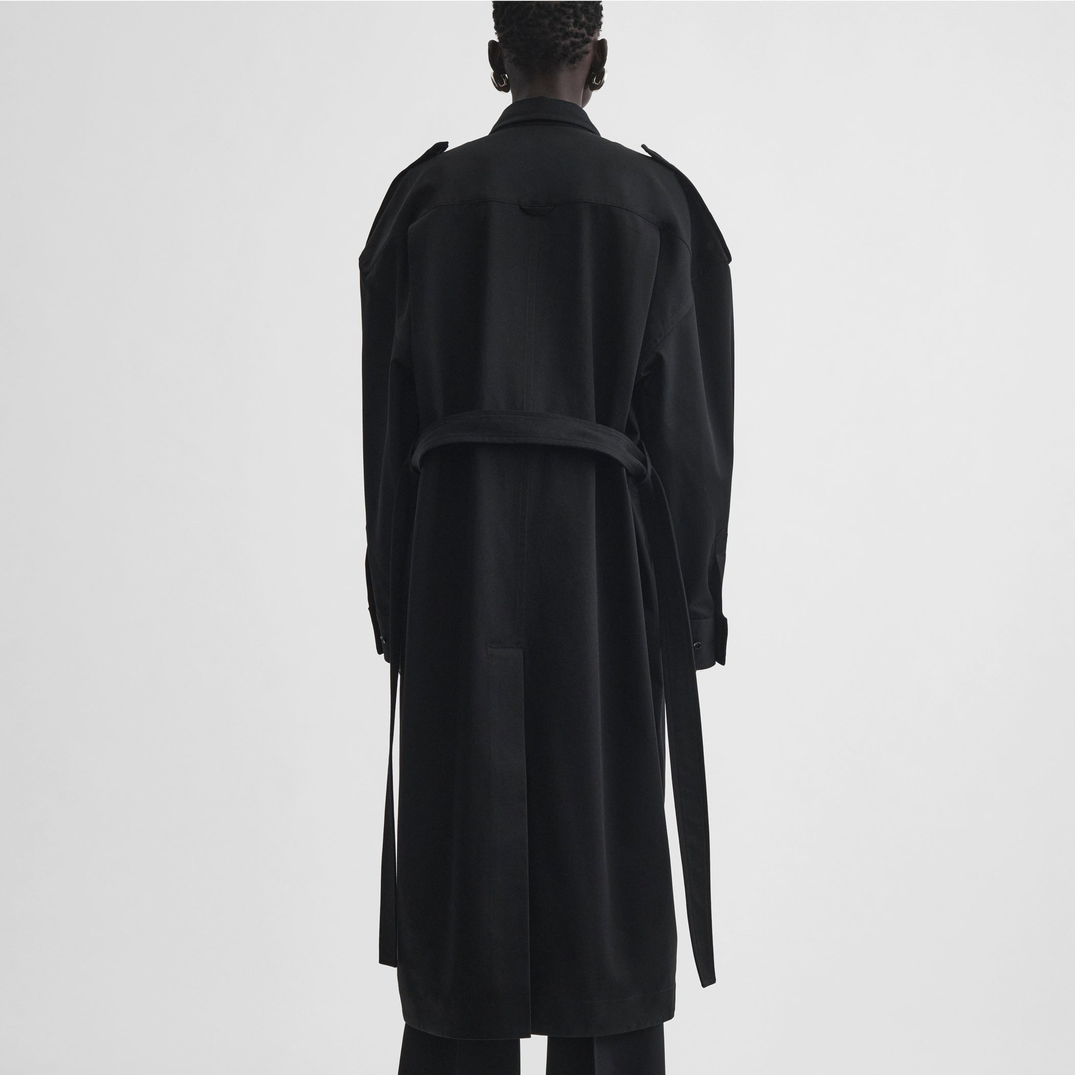 Back full body view of model wearing utility shirt dress in black cotton
