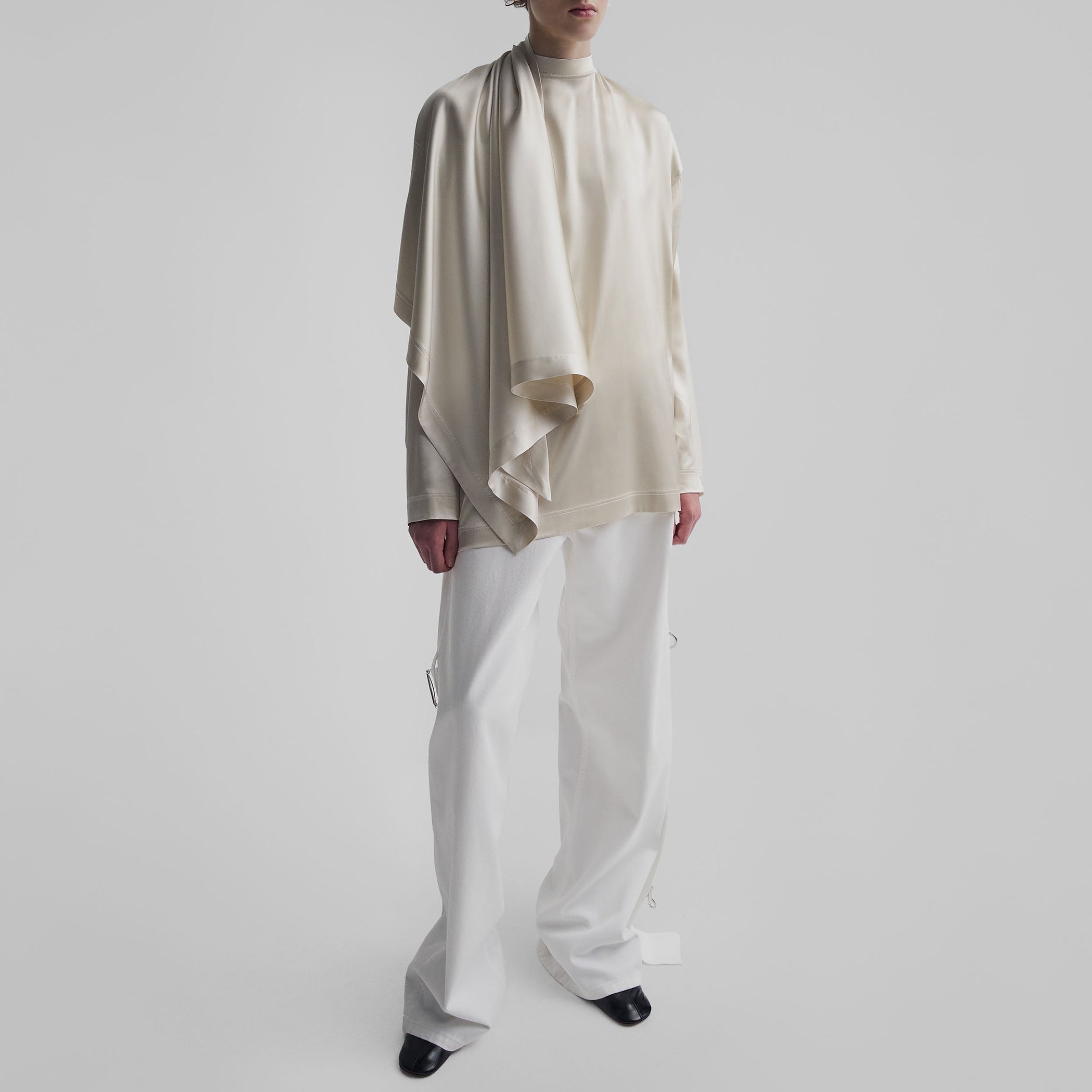 Angled front view of model wearing SCARF TOP in stucco silk satin