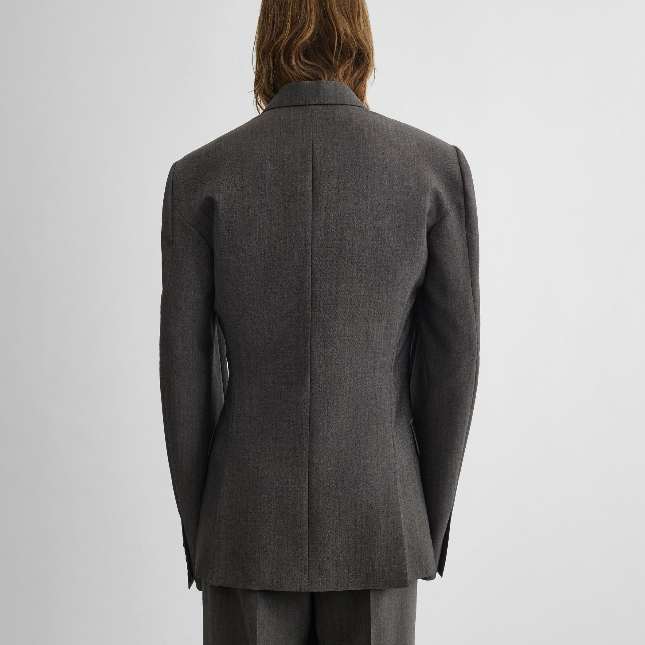 Back view of model wearing SINGLE BREASTED JACKET in dark taupe wool