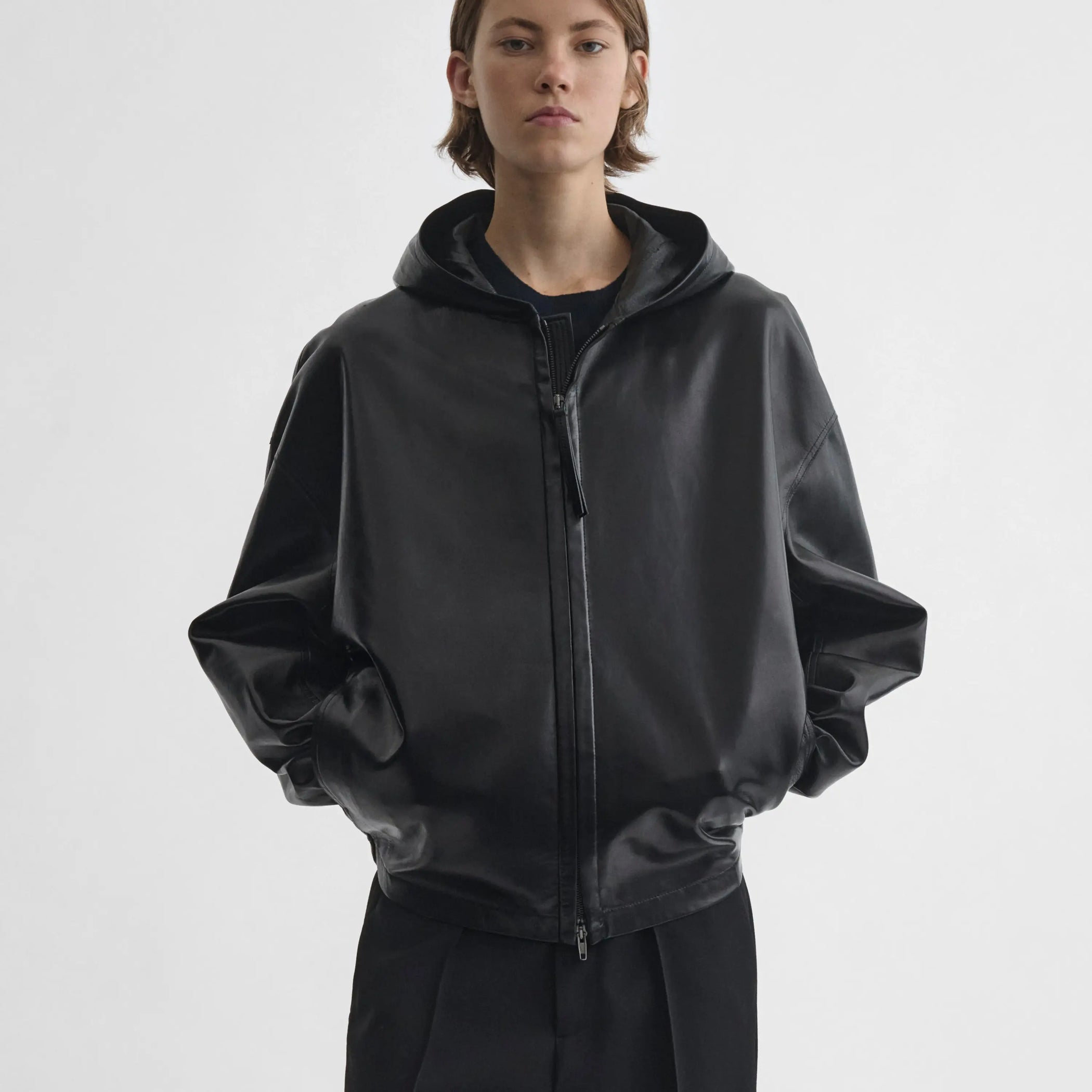 Front view of model wearing Hooded Bomber in black.