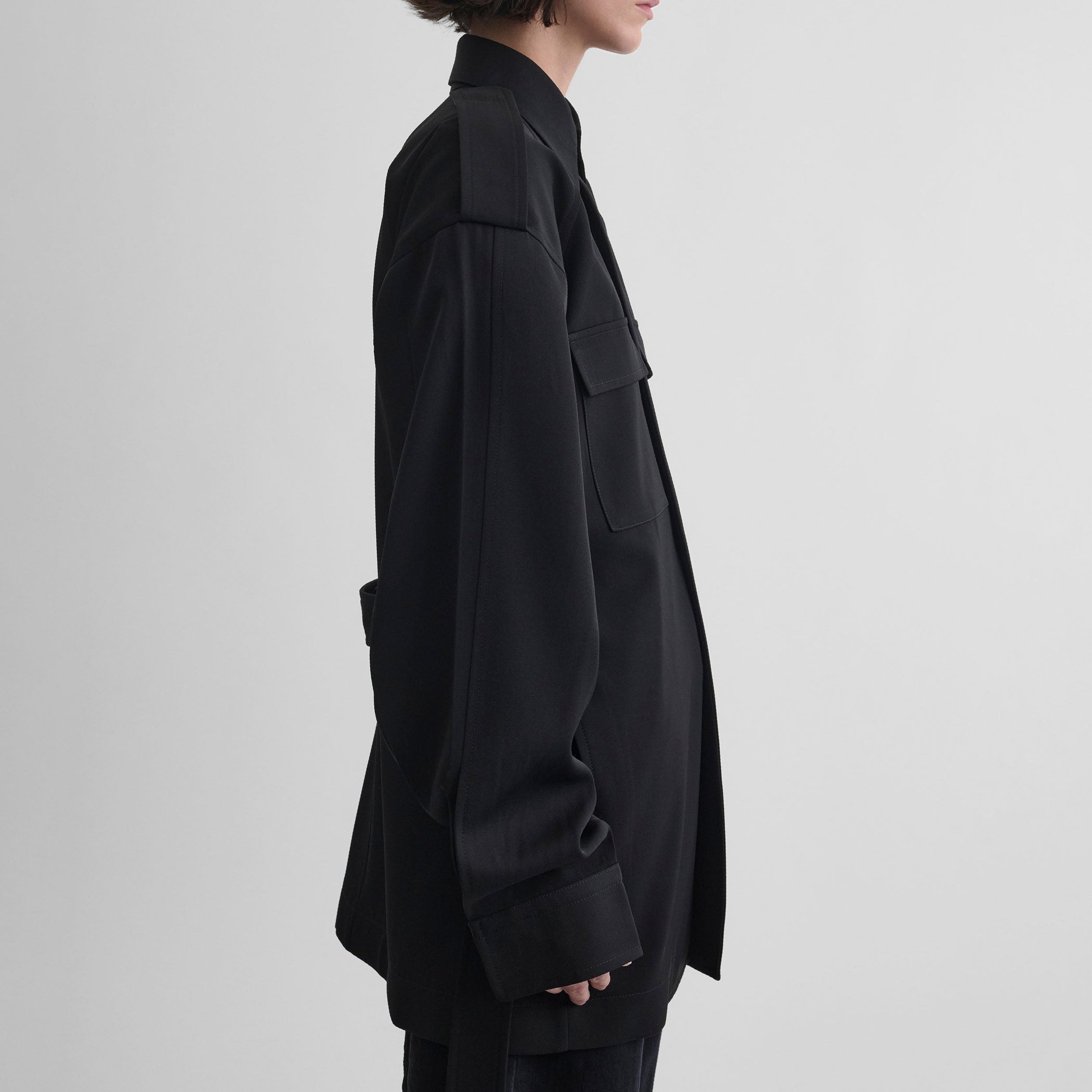 Side view of model wearing LIGHTWEIGHT SHIRT JACKET in black wool