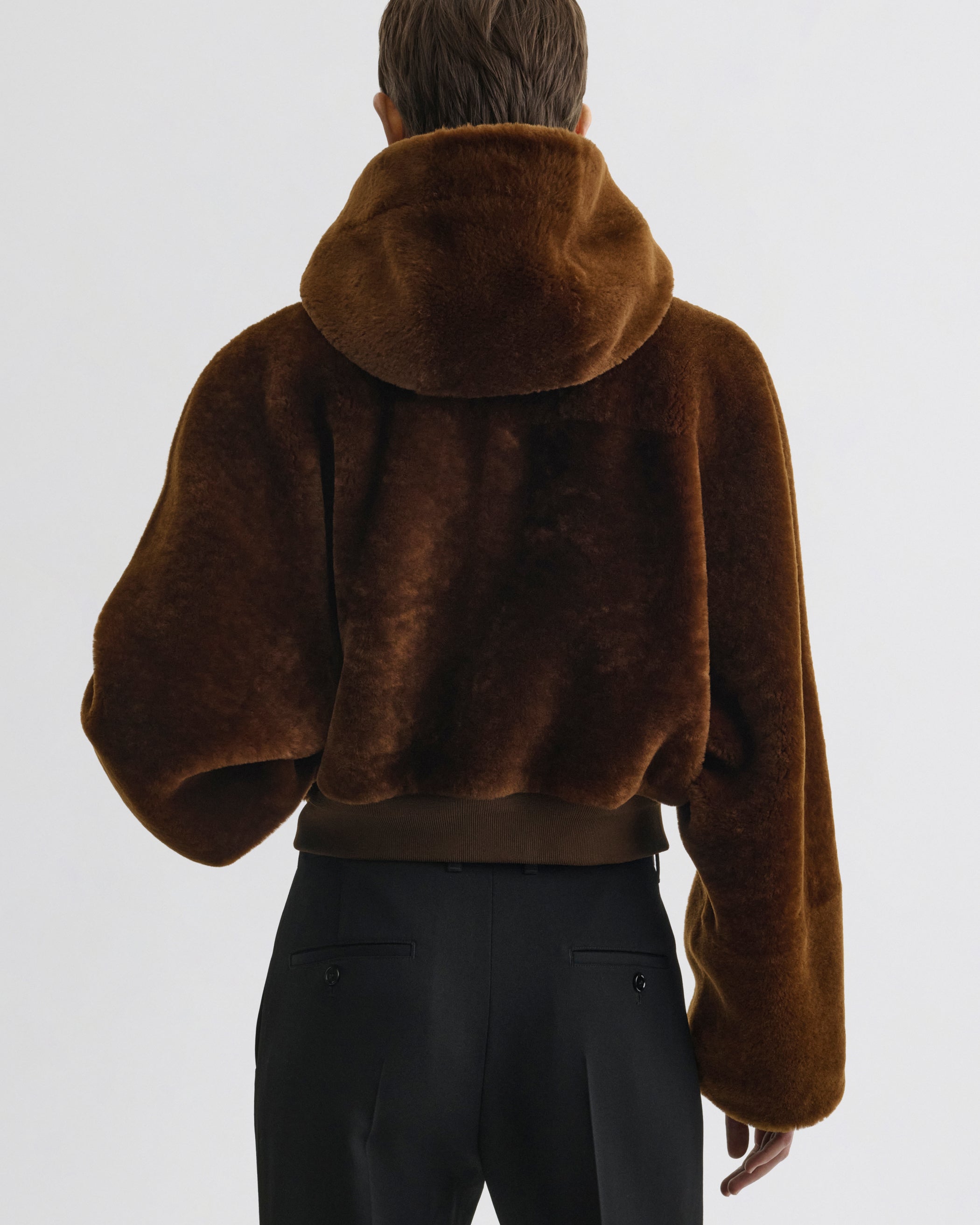 Back view of model wearing Super Soft Bomber Jacket in ginger shearling