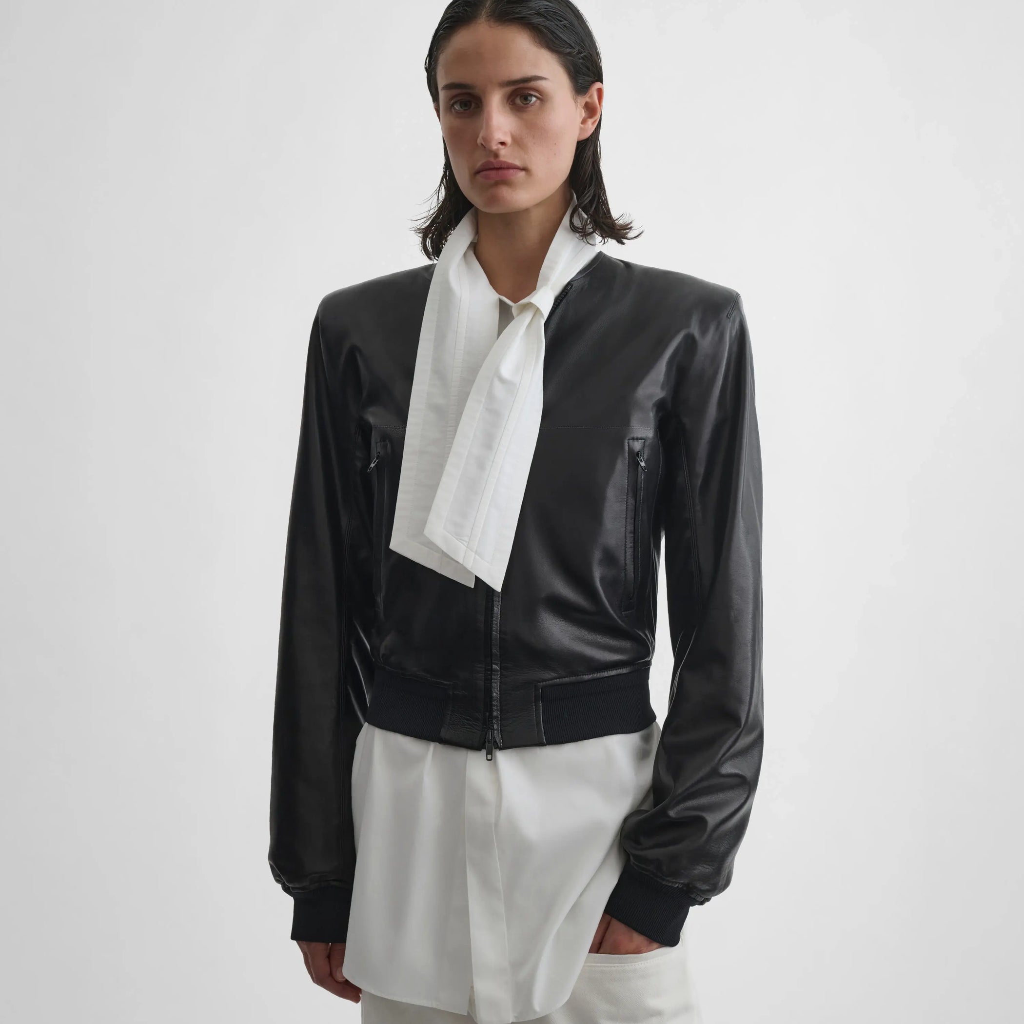 Front view of model wearing sharp shoulder jacket in black