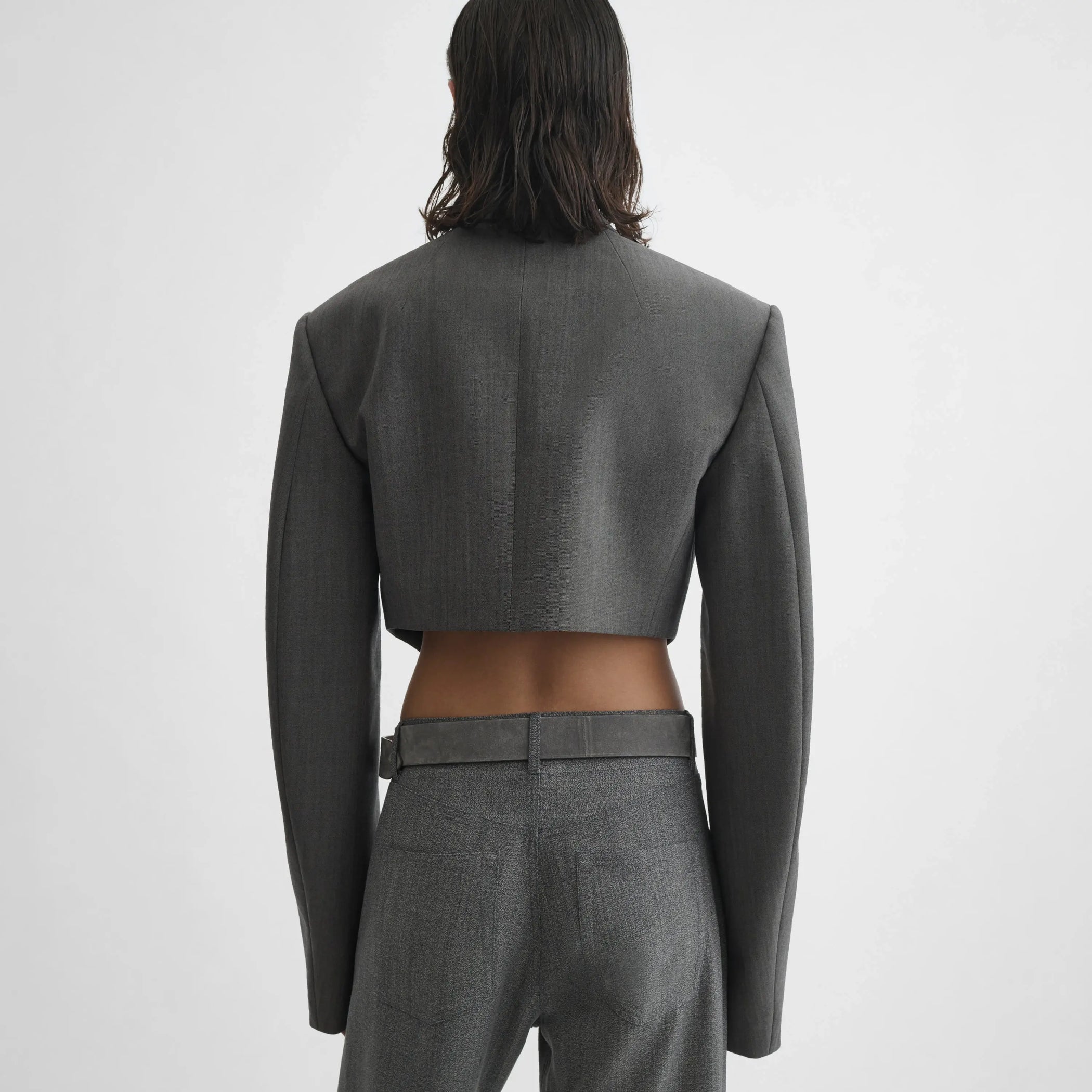 Back view of model wearing Tucked Tailored Jacket in dark taupe.
