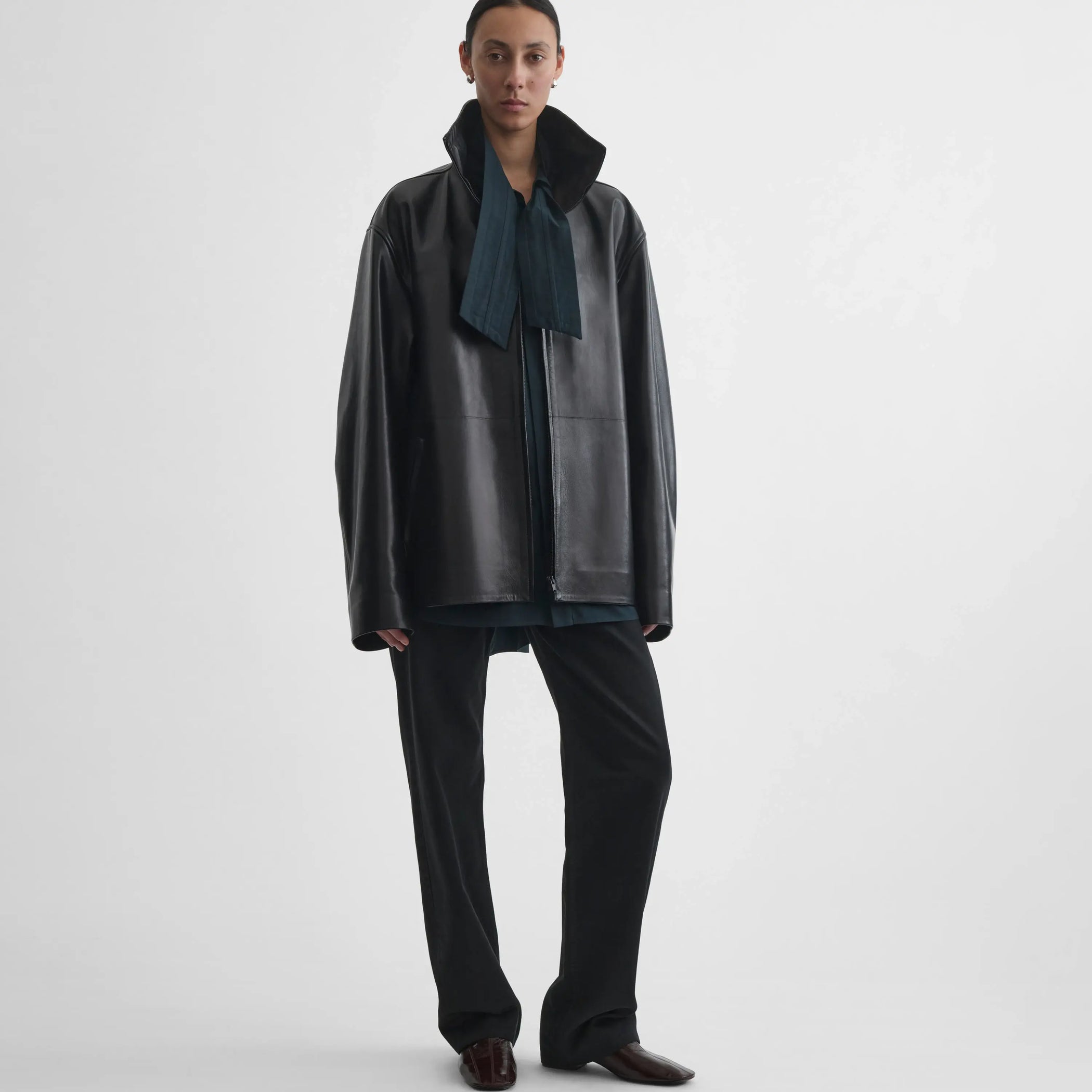 Full body front view of model wearing Funnel Jacket in black. 
