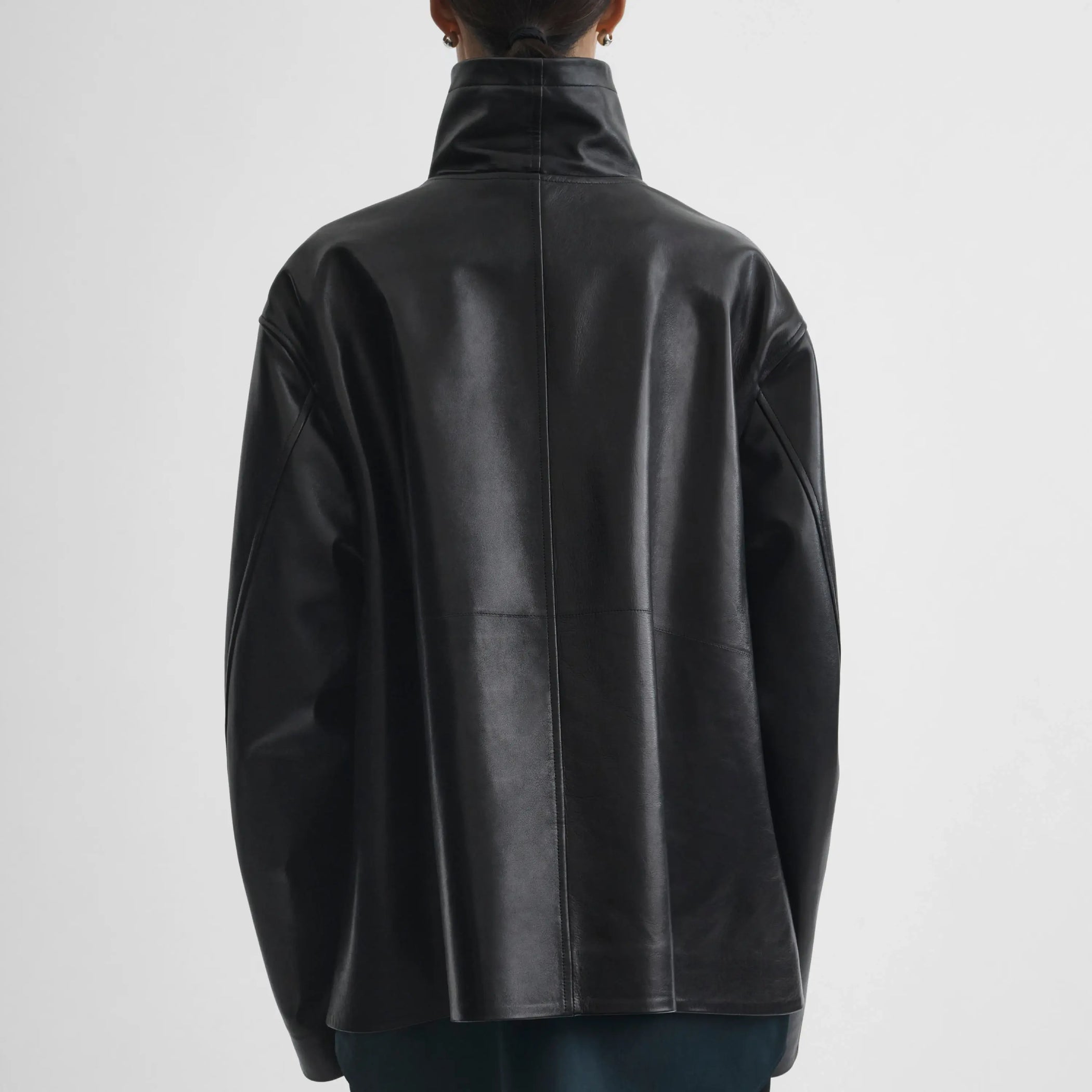 Back view of model wearing Funnel Jacket in black.