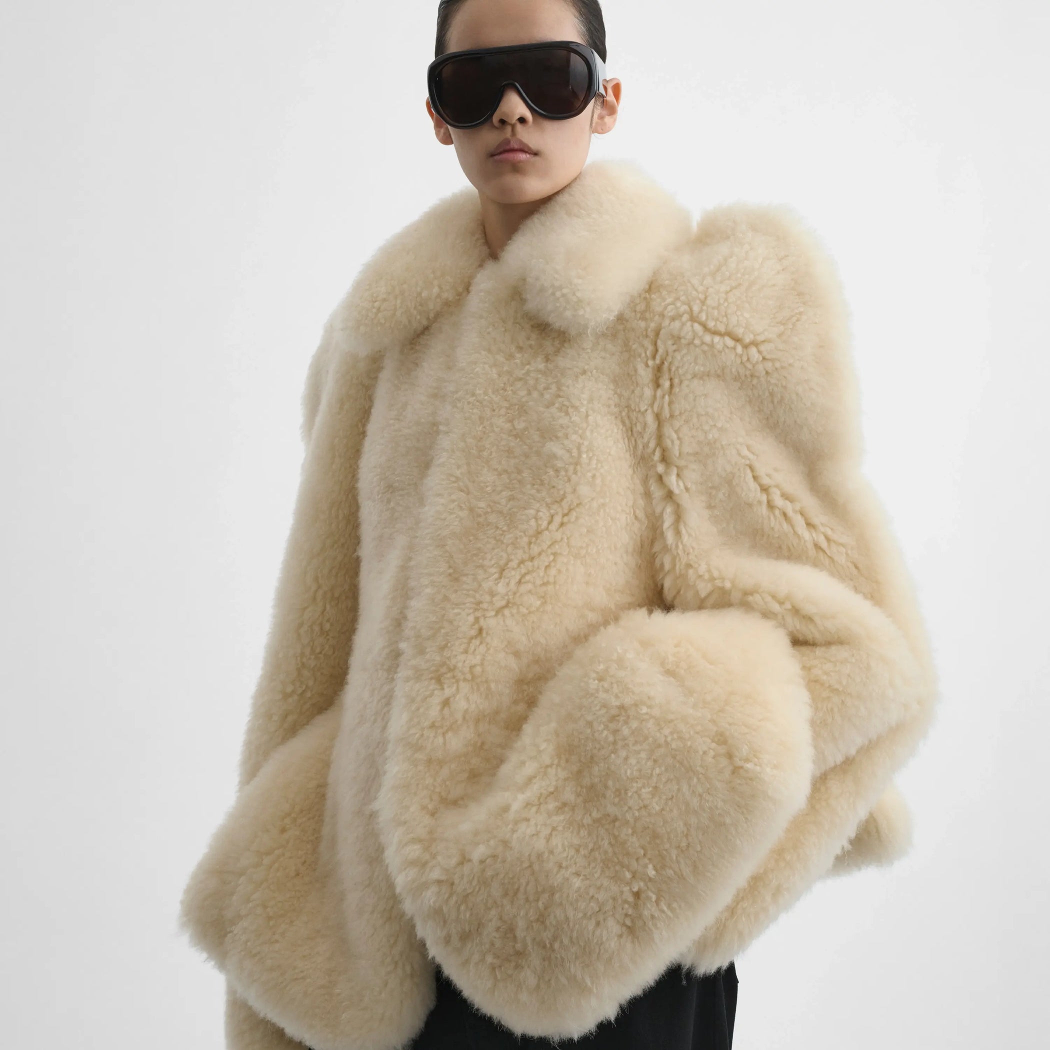 Close up front view of model wearing Teddy Jacket in warm vanilla.
