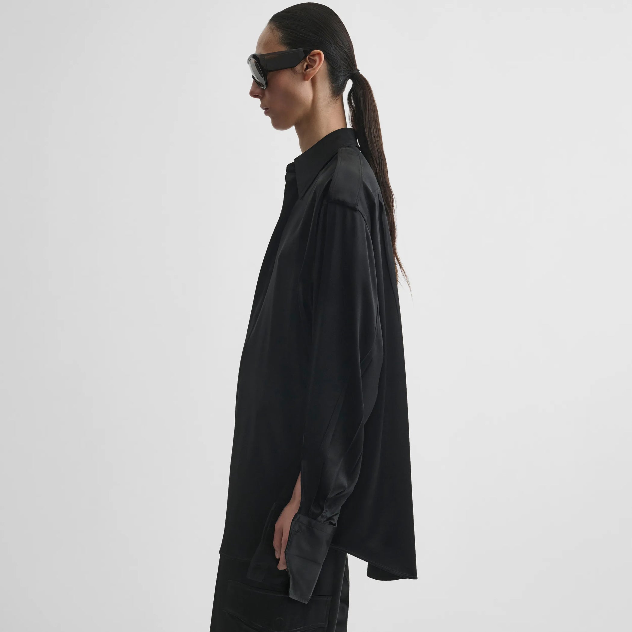 Side model view of liquid utility shirt in black silk satin