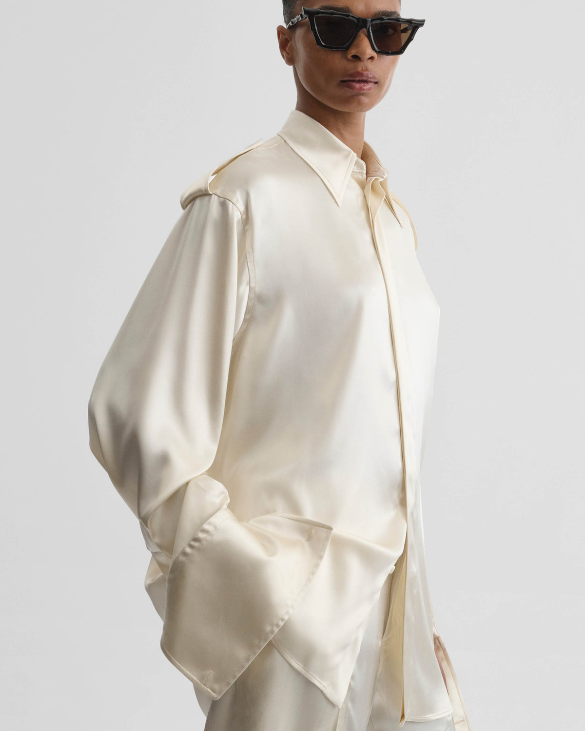 Front detail view of model wearing LIQUID UTILITY SHIRT in cream silk satin