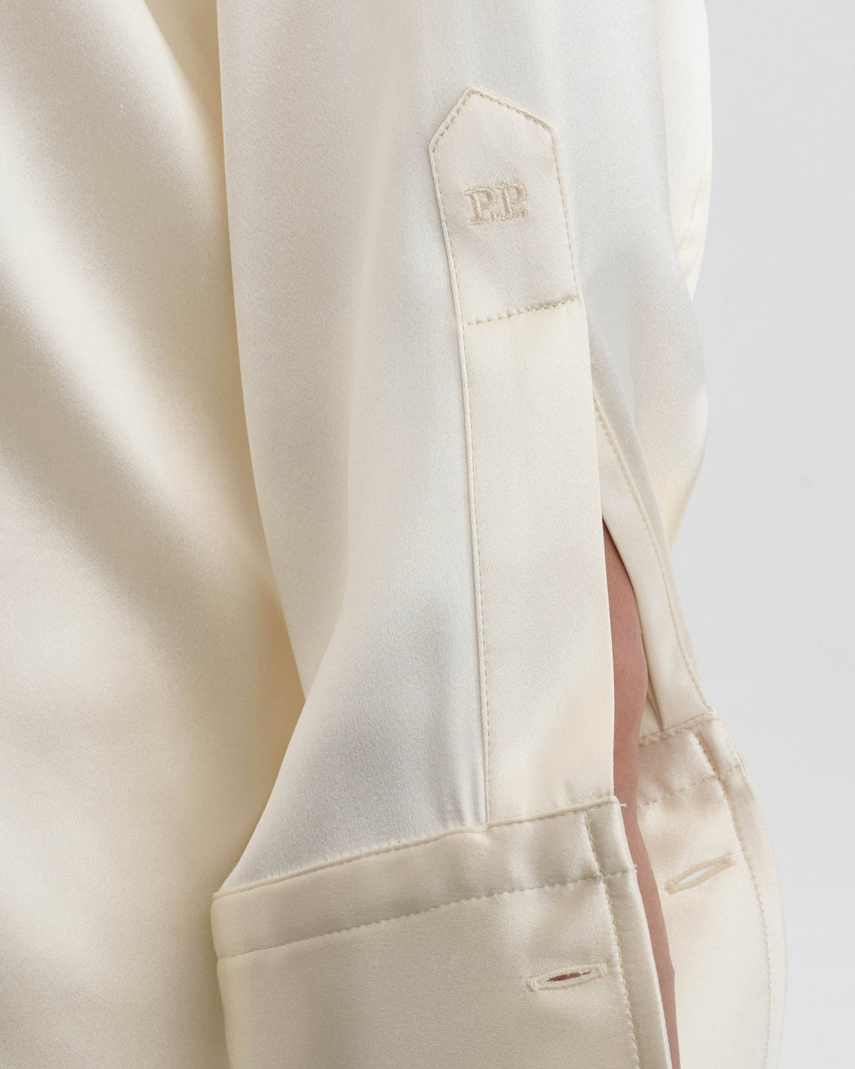 Detail view of model wearing LIQUID UTILITY SHIRT in cream silk satin