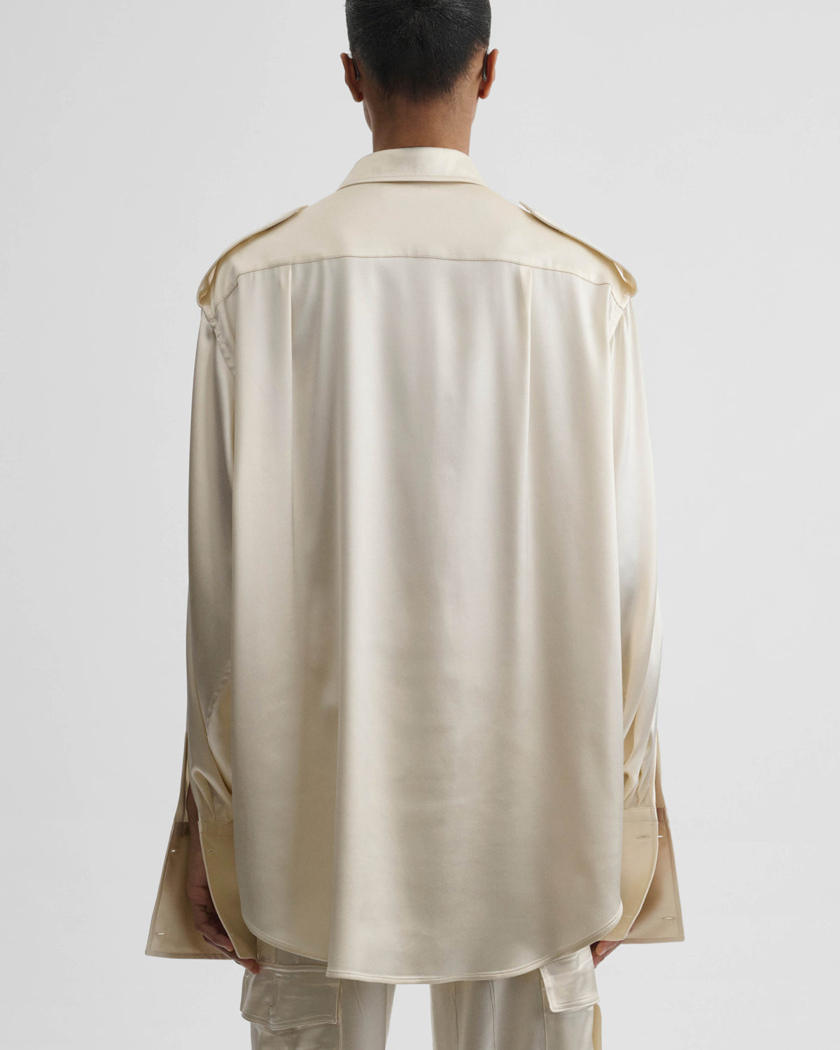 Back view of model wearing LIQUID UTILITY SHIRT in cream silk satin