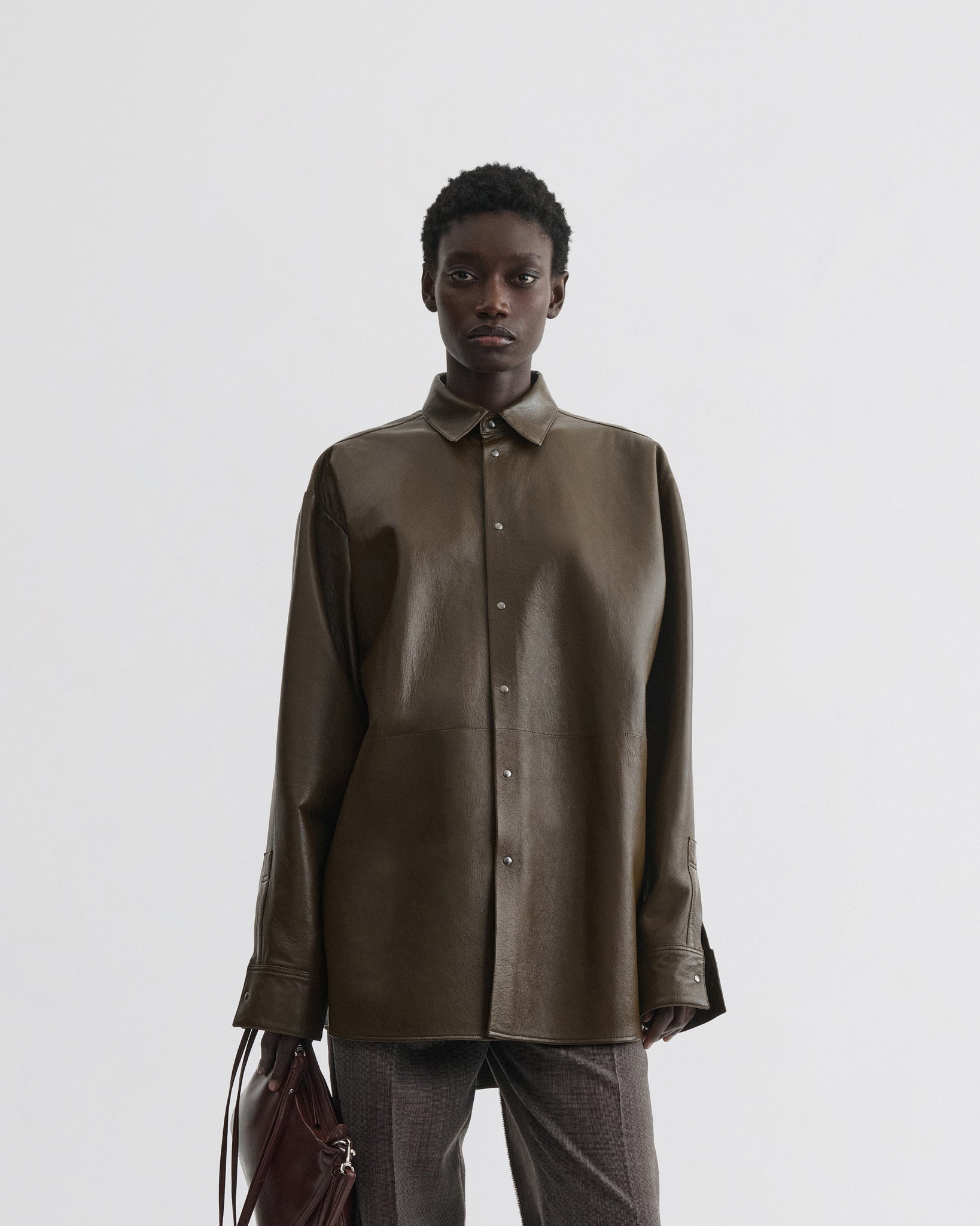 Front view of model wearing overshirt in green bronze leather.