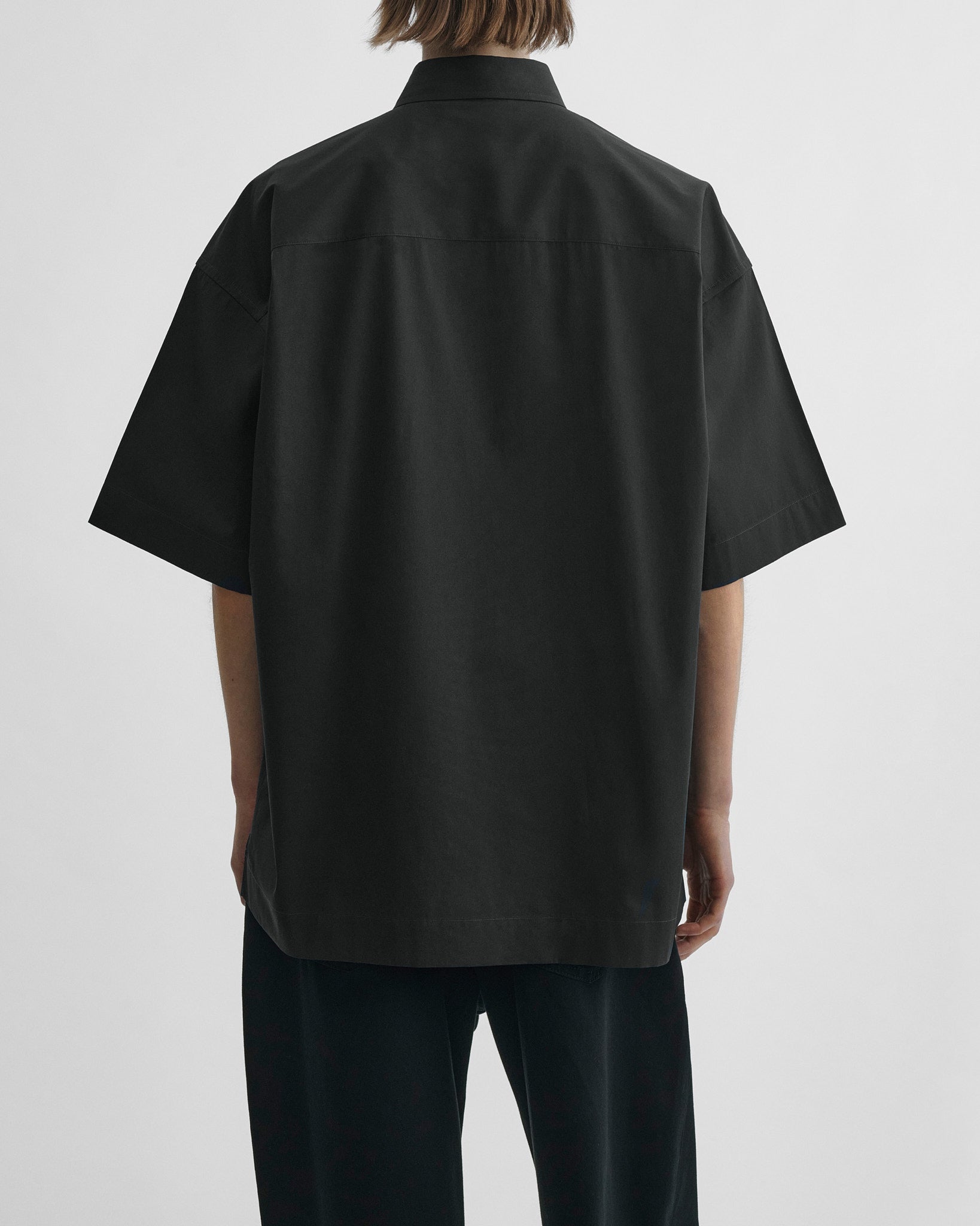 Back view of short sleeve shirt in black cotton