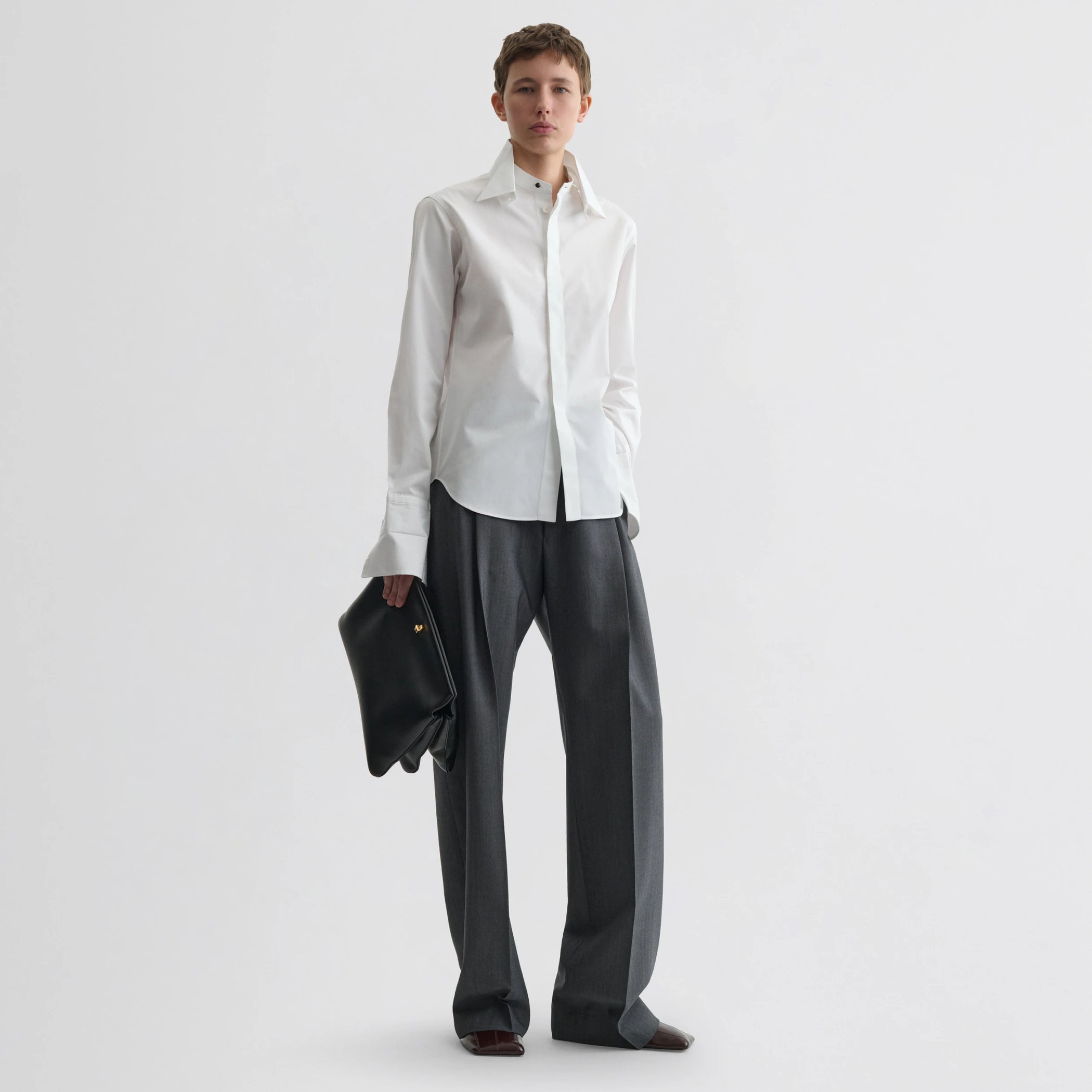 Front view of model wearing tuxedo shirt in white cotton.