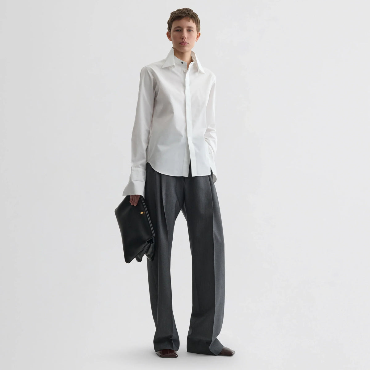 Front view of model wearing tuxedo shirt in white cotton.