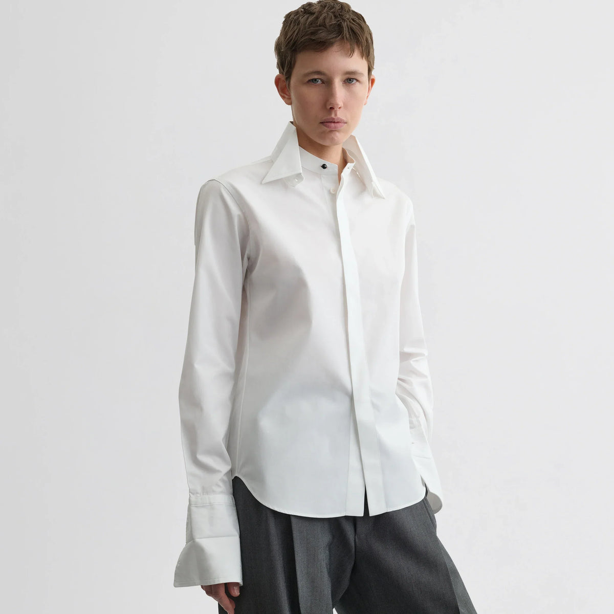 Front view of model wearing tuxedo shirt in white cotton