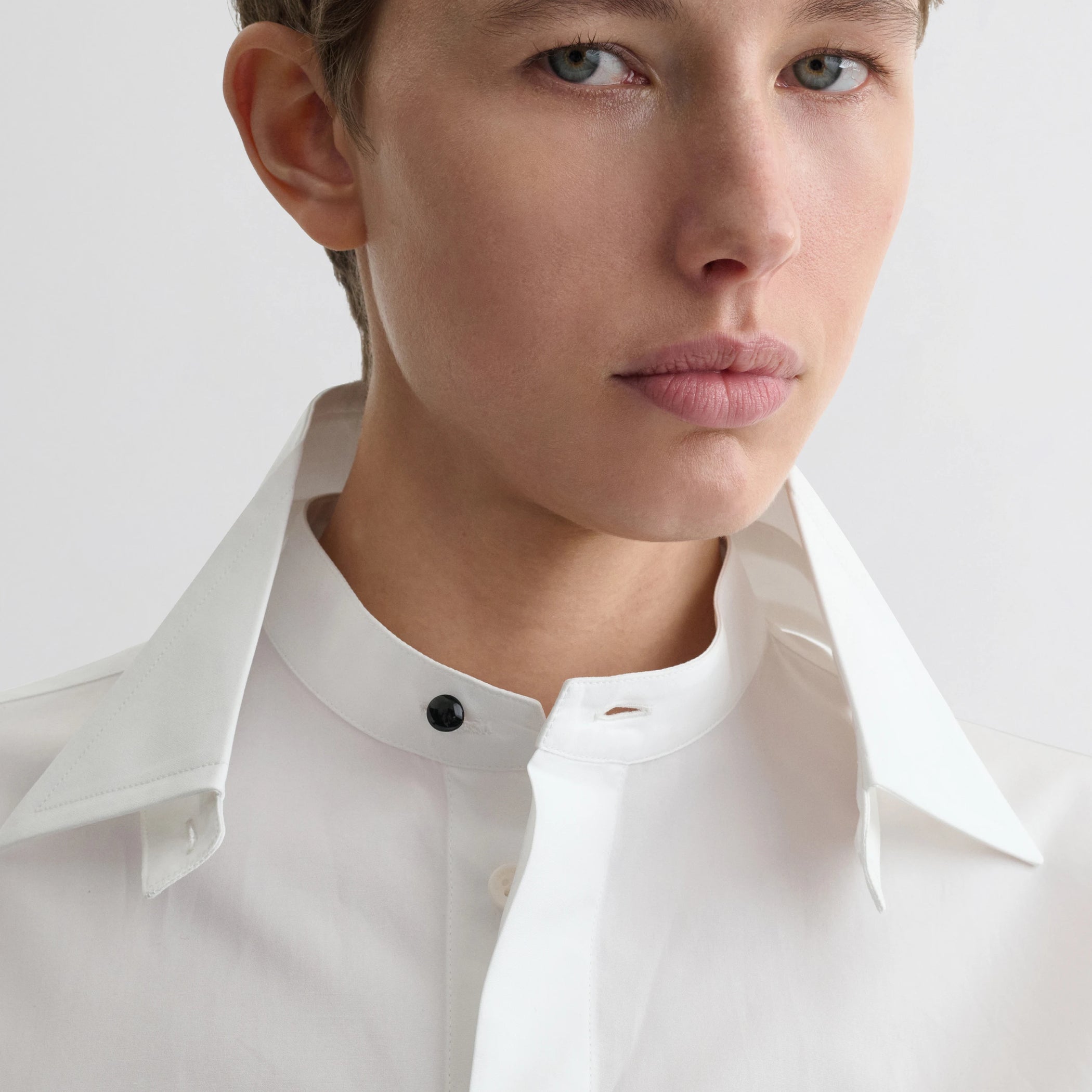 Close up detail view of tuxedo shirt in white cotton.