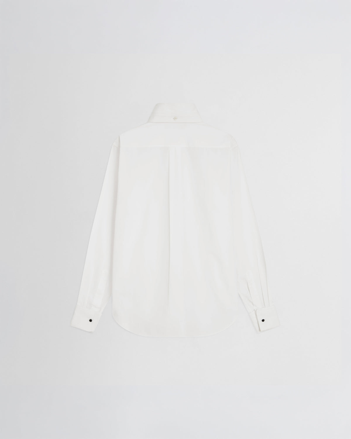 Flat back view of tuxedo shirt in white cotton.