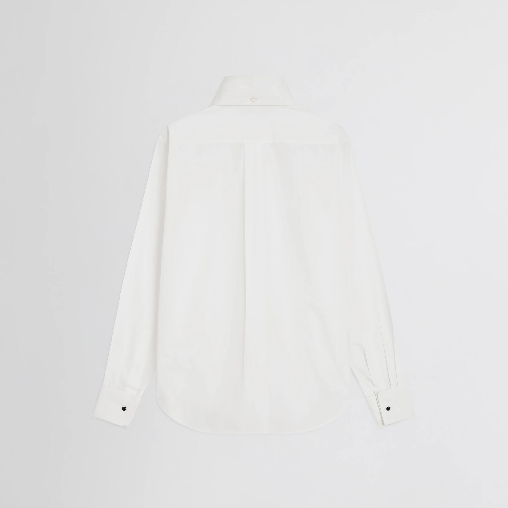 Flat back view of tuxedo shirt in white cotton.