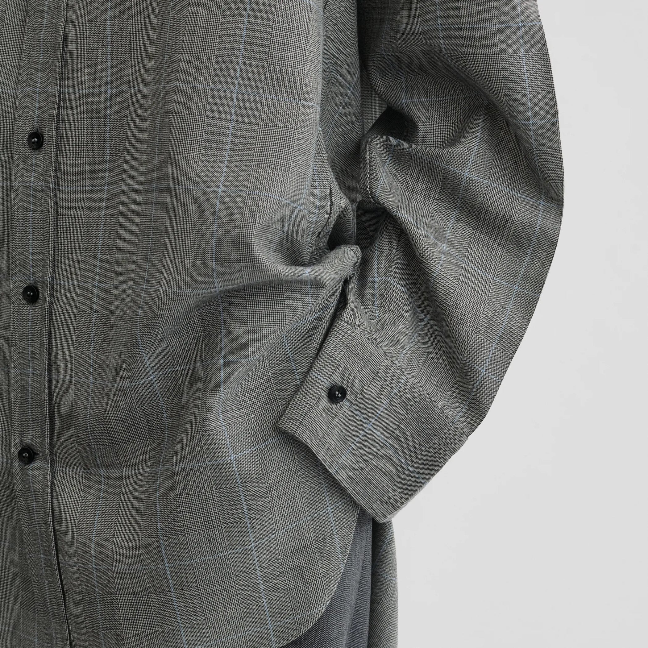 Close up detail view of elongated shirt in black-blue wool