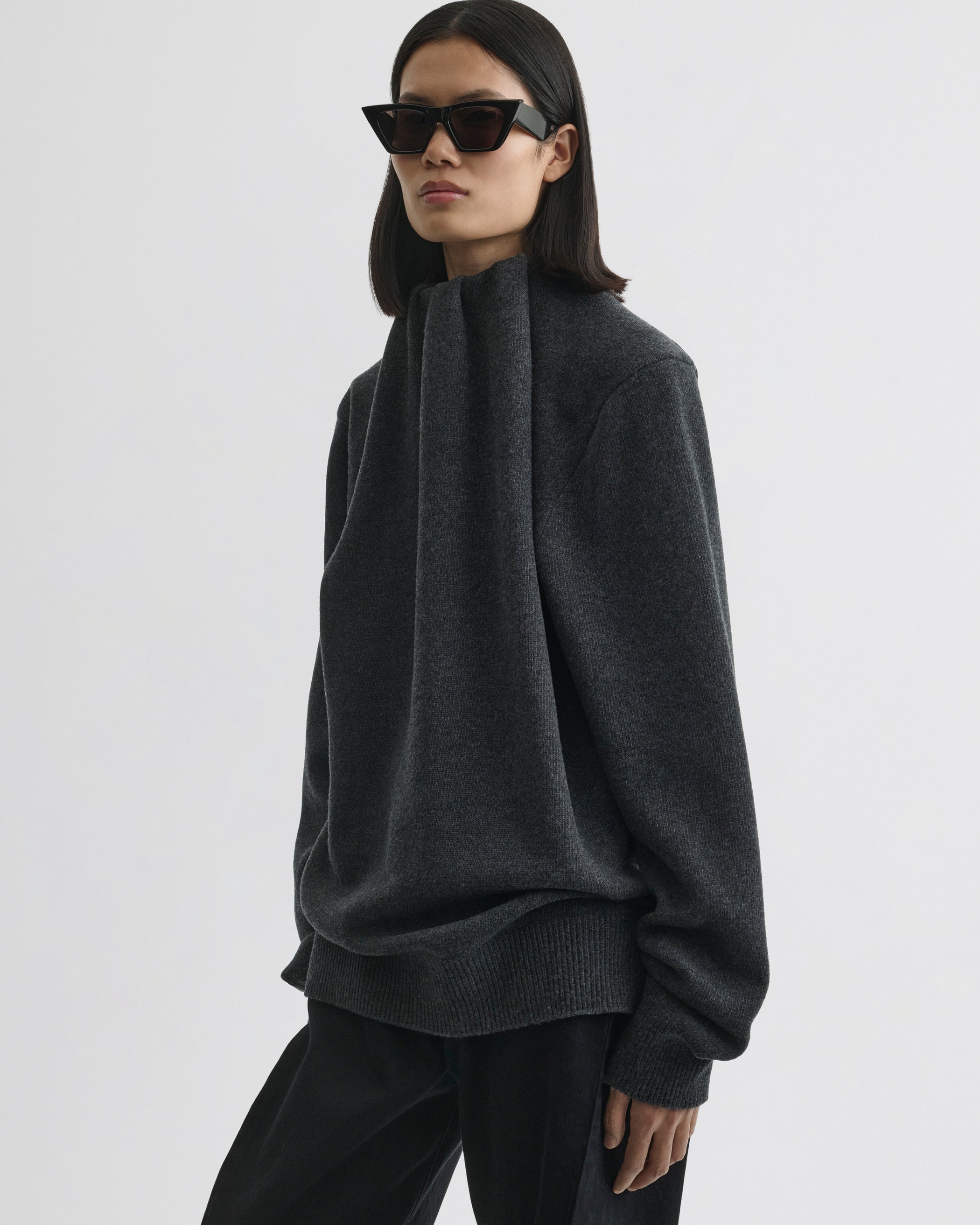 Side view of model wearing SOFT RIDGE JUMPER in grey melange wool