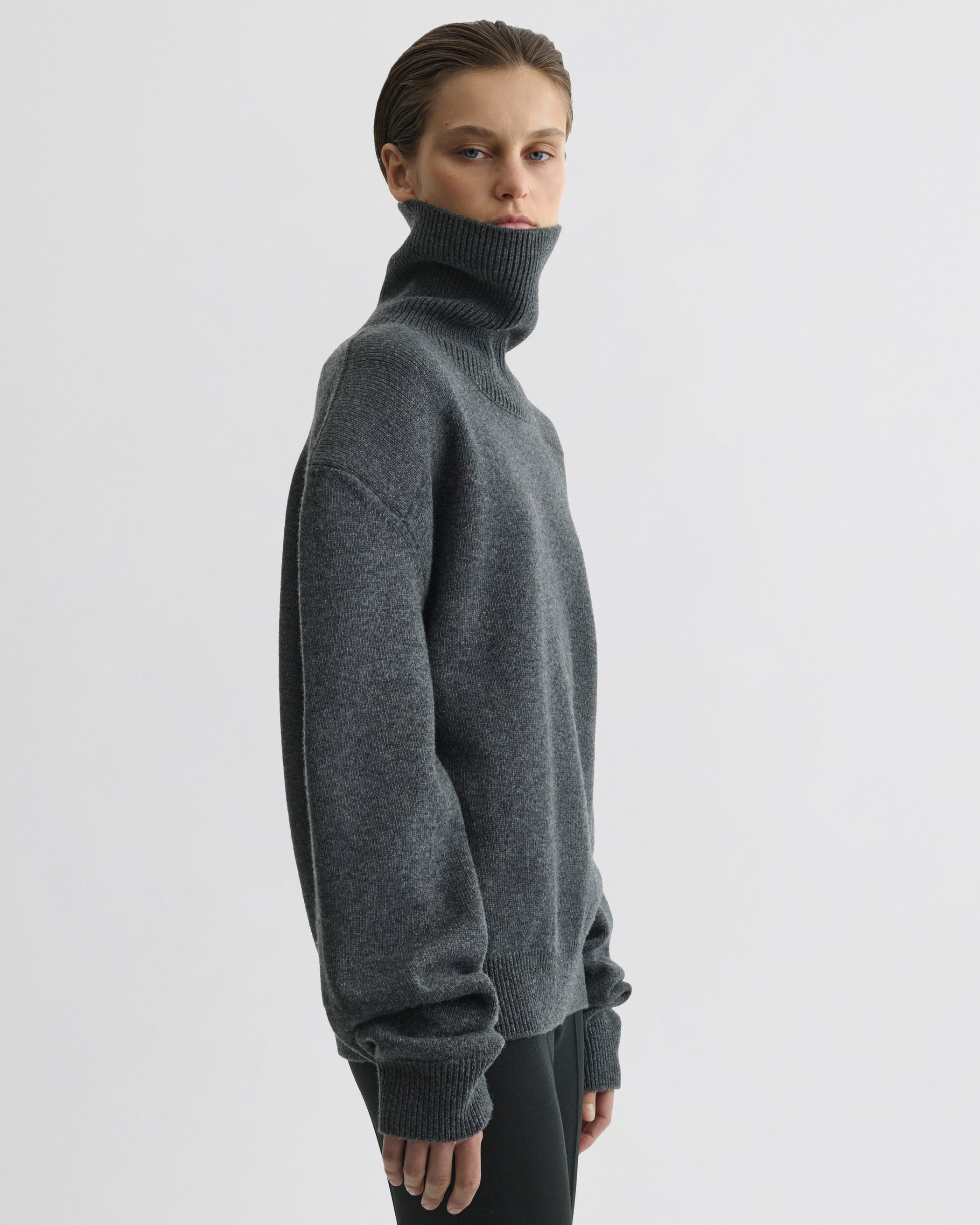 Side view of model wearing Patch Shoulder Jumper in grey melange wool cashmere
