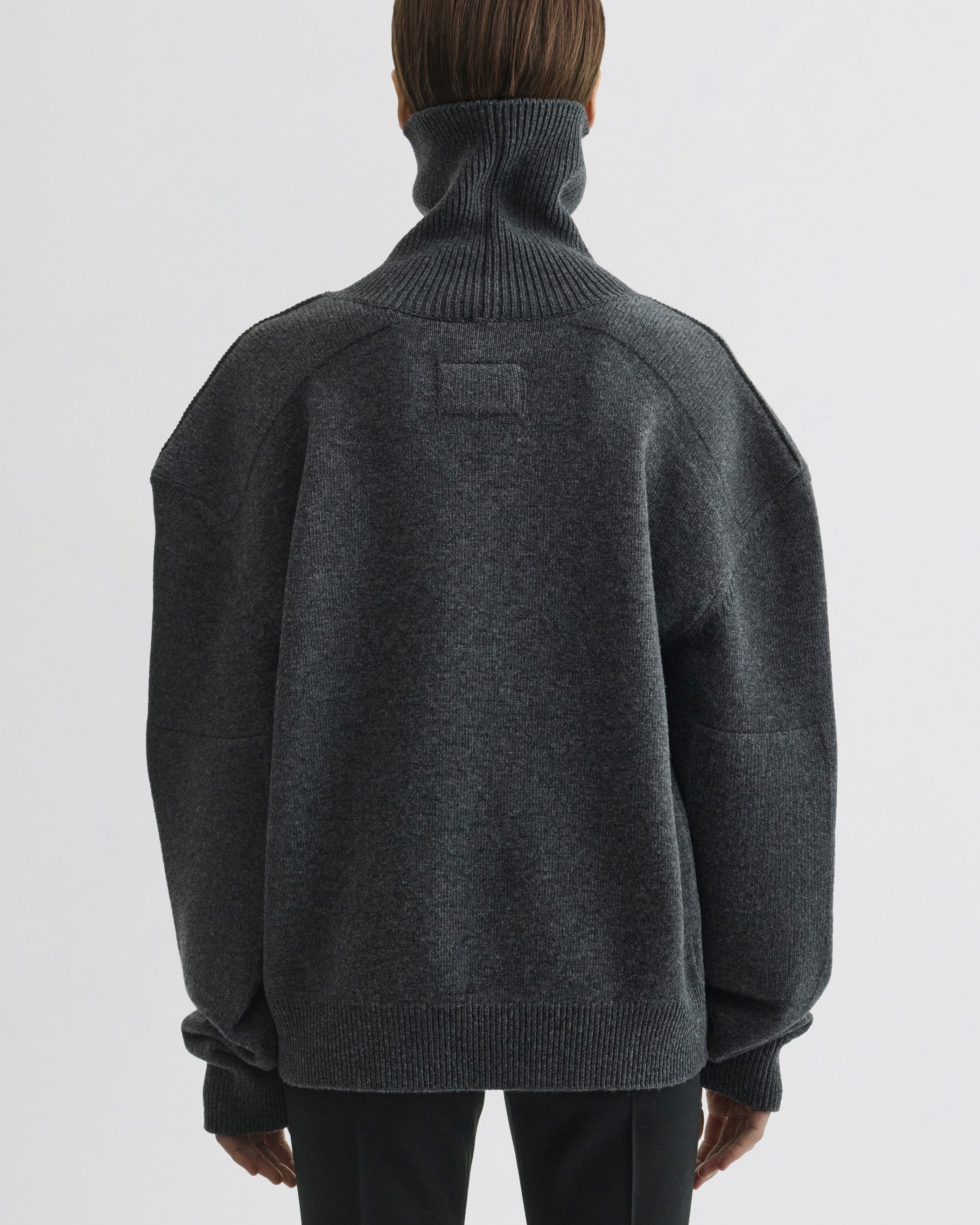 Back view of model wearing Patch Shoulder Jumper in grey melange wool cashmere