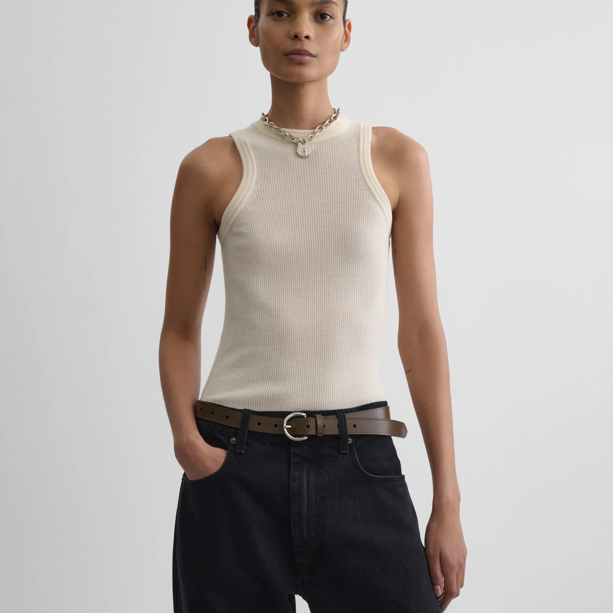 Front view model wearing light merino wool rib tank top in cream