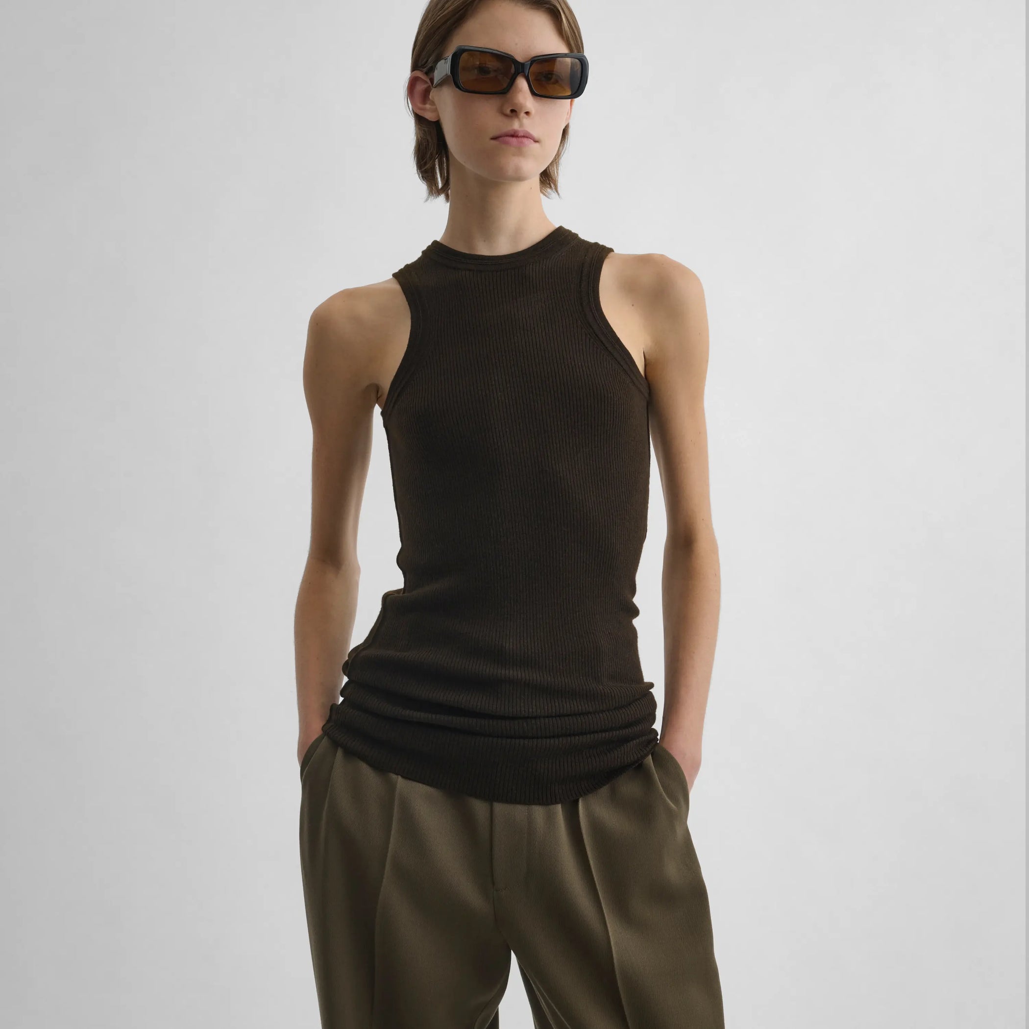 Front view of model wearing Ribbed Tank in dark khaki.