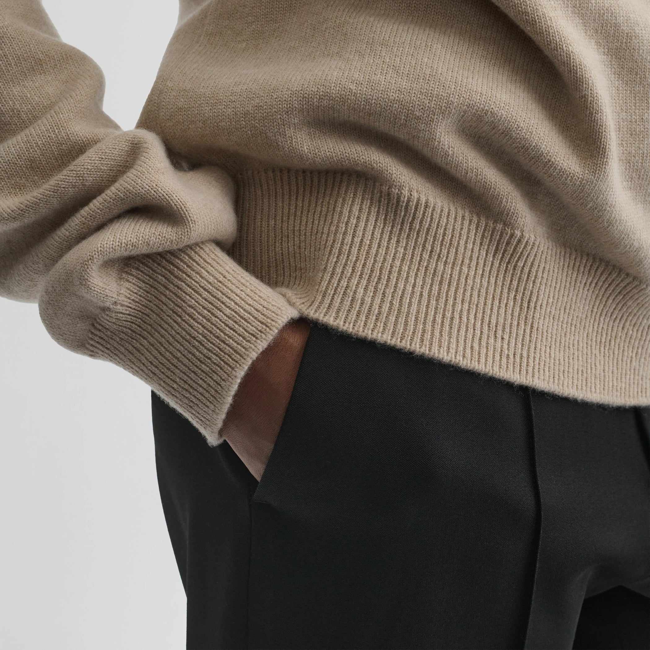 Close up detail view of easy v-neck sweater in beige wool cashmere.