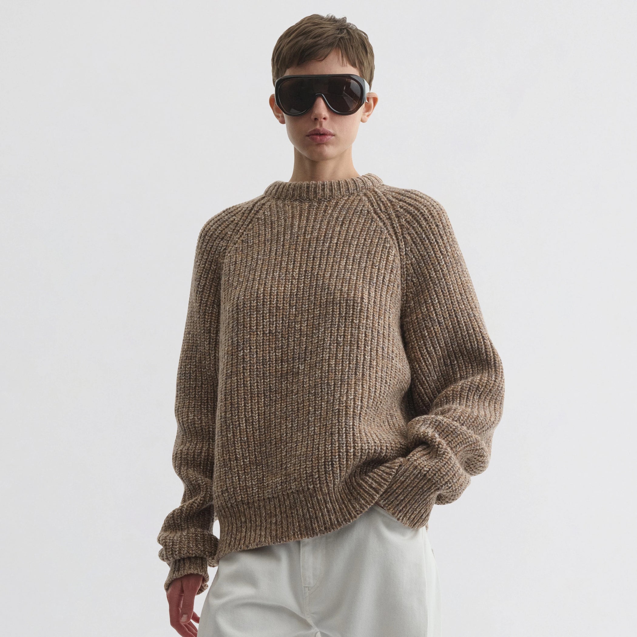 Front view of model wearing mouline jumper in camel wool.