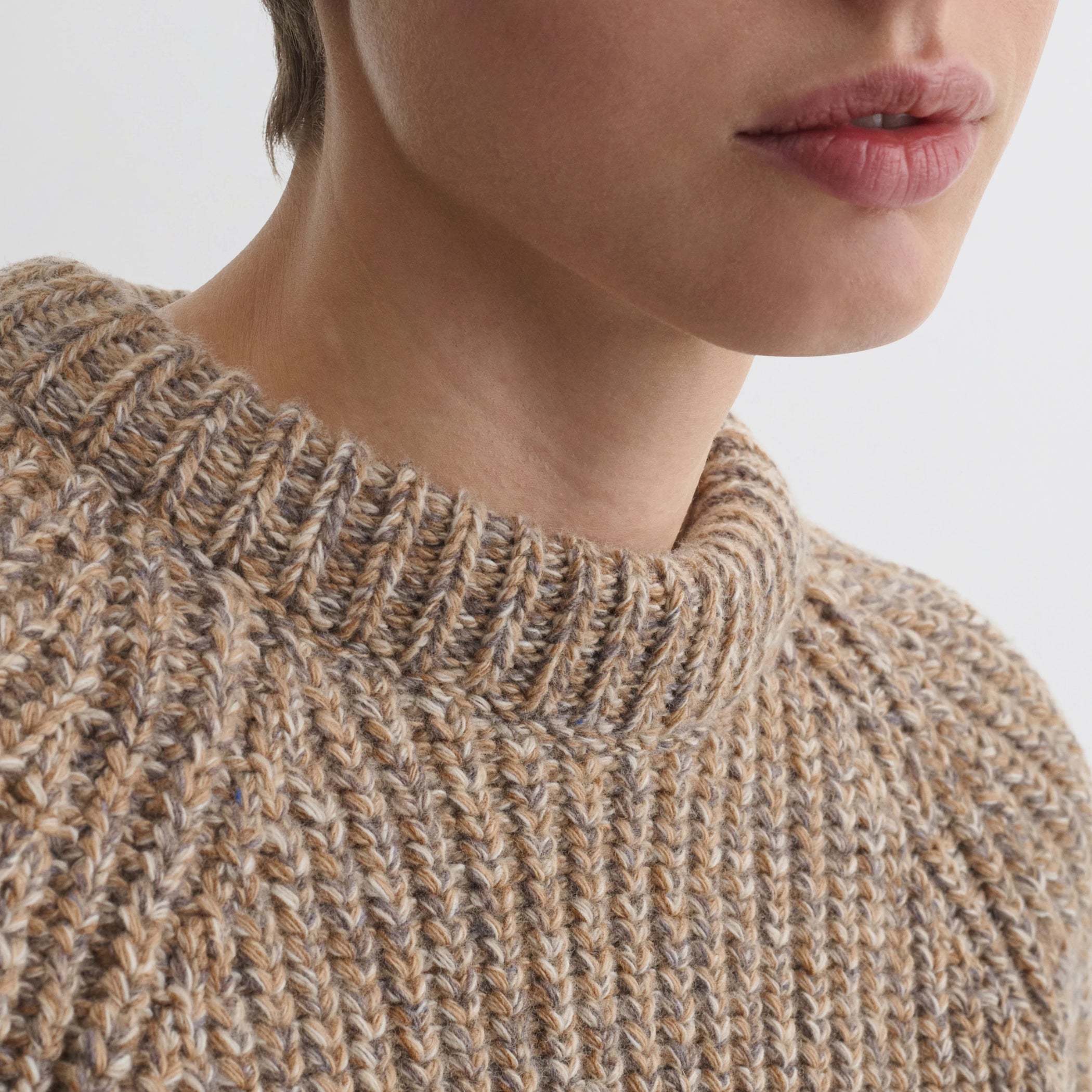 Close up detail view of mouline jumper in camel wool.