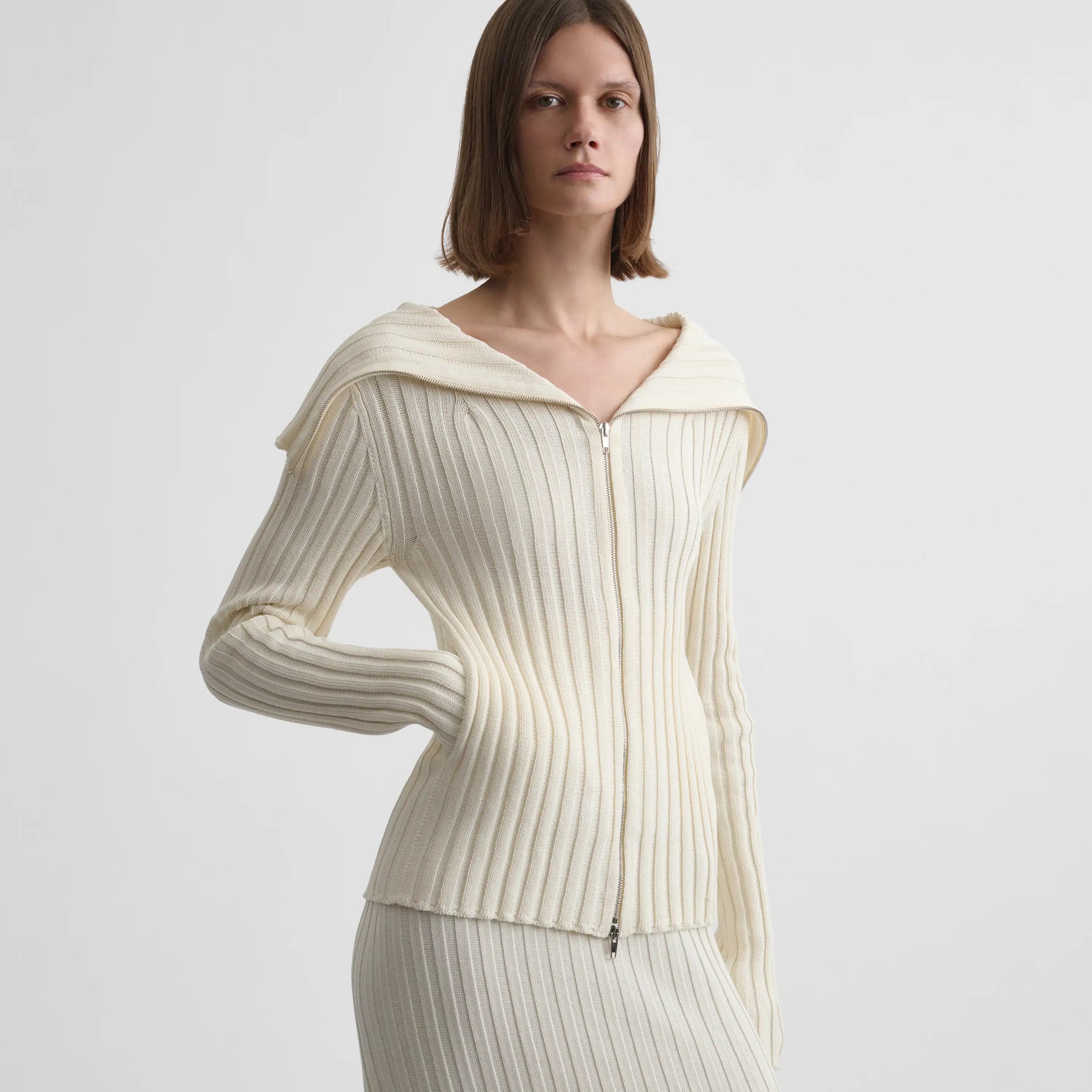 Close up view of model wearing the funnel neck cardigan in cream
