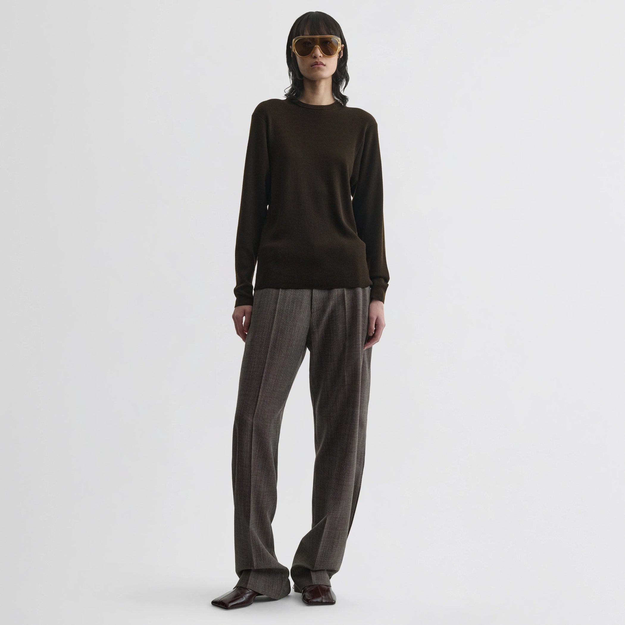 Front view of model wearing batwing crewneck in dark khaki wool.