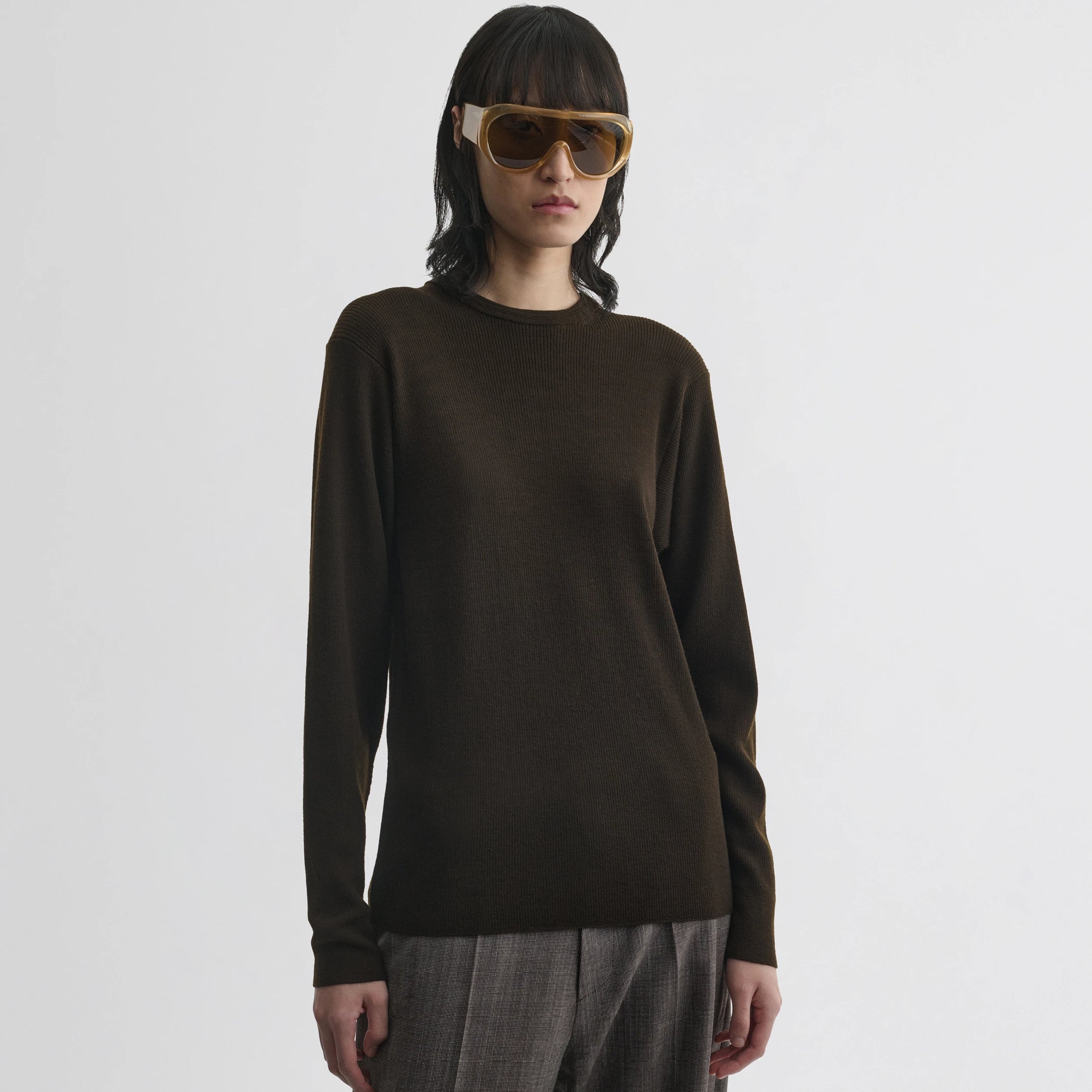 Front view of model wearing batwing crewneck in dark khaki wool.