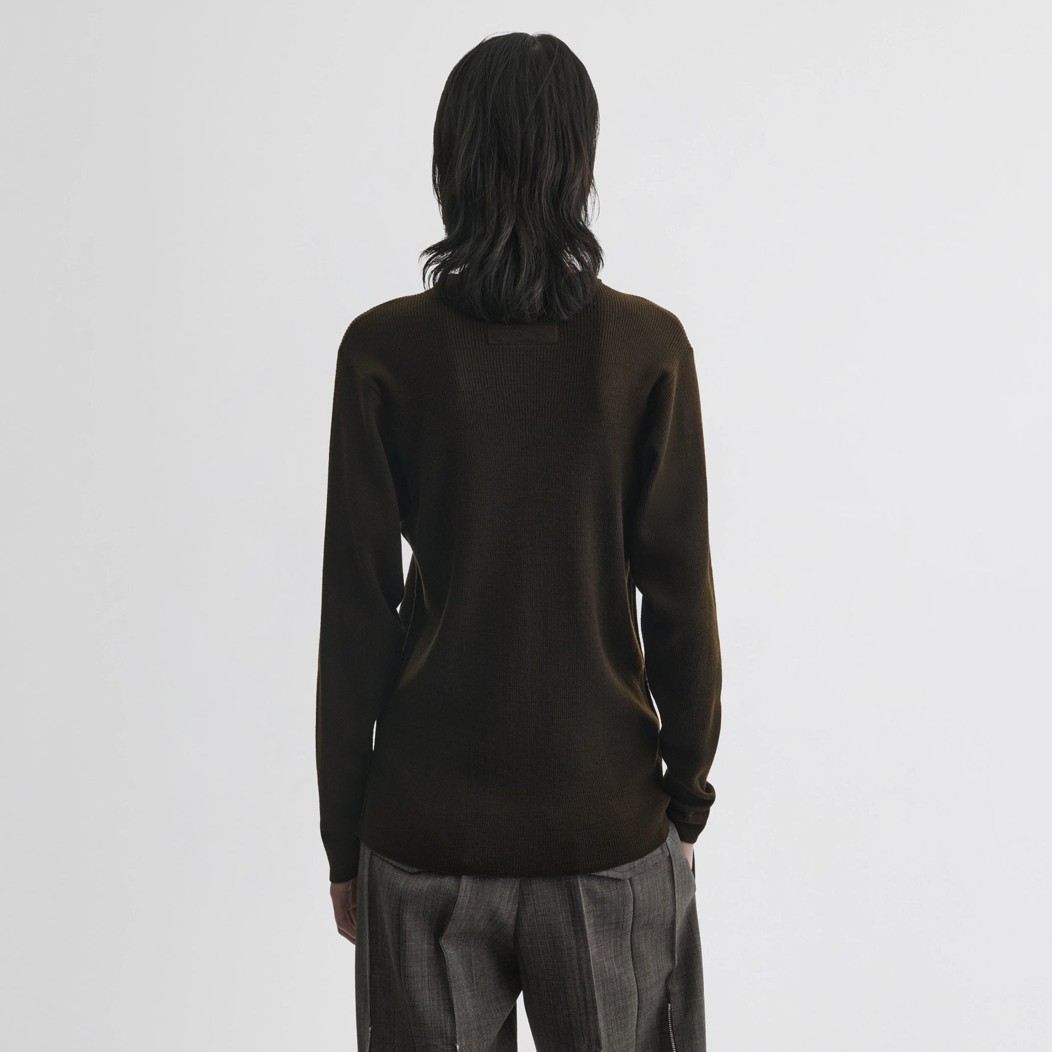 Back view of model wearing batwing crewneck in dark khaki wool.