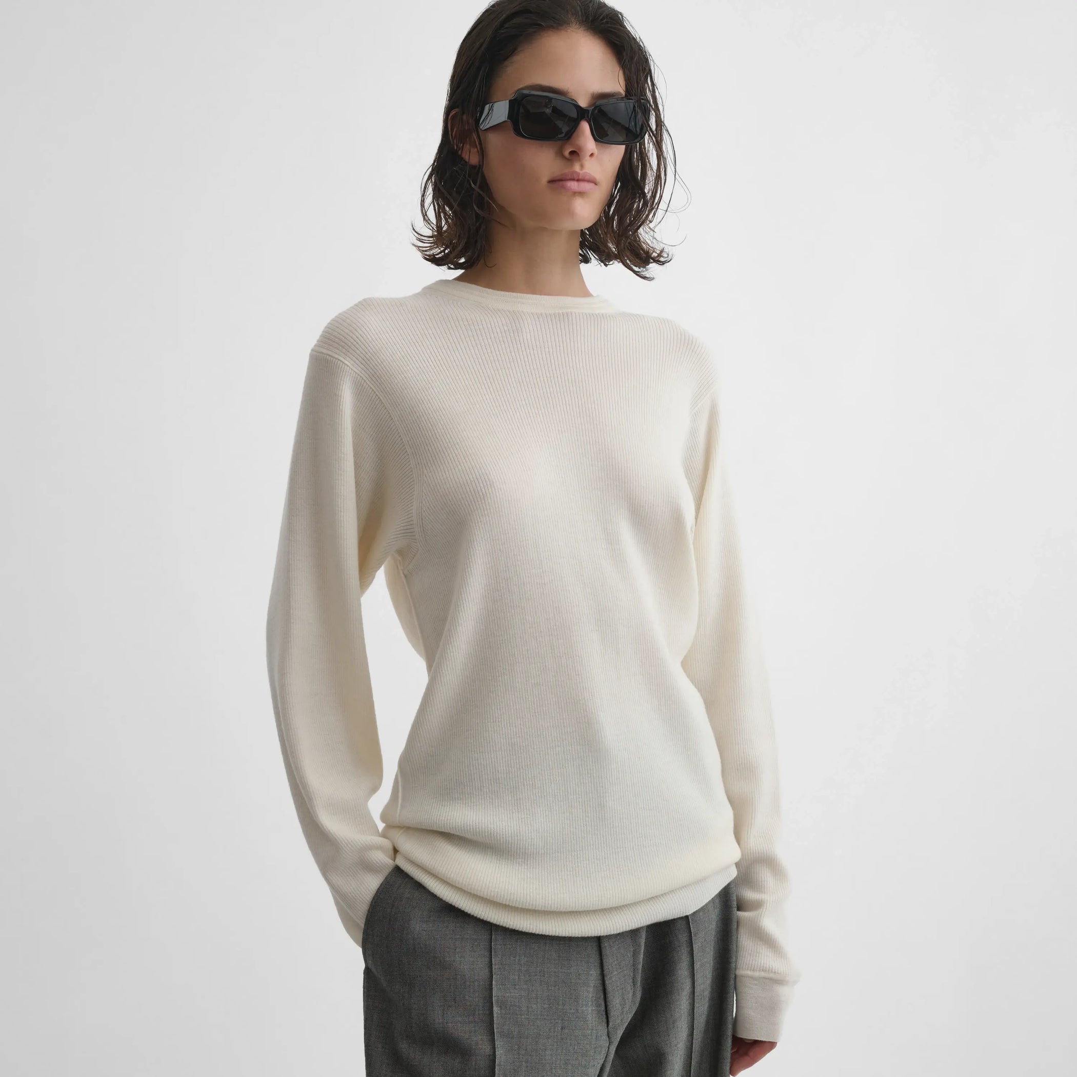 Front view of model wearing Ribbed Long Sleeve Crewneck in cream.