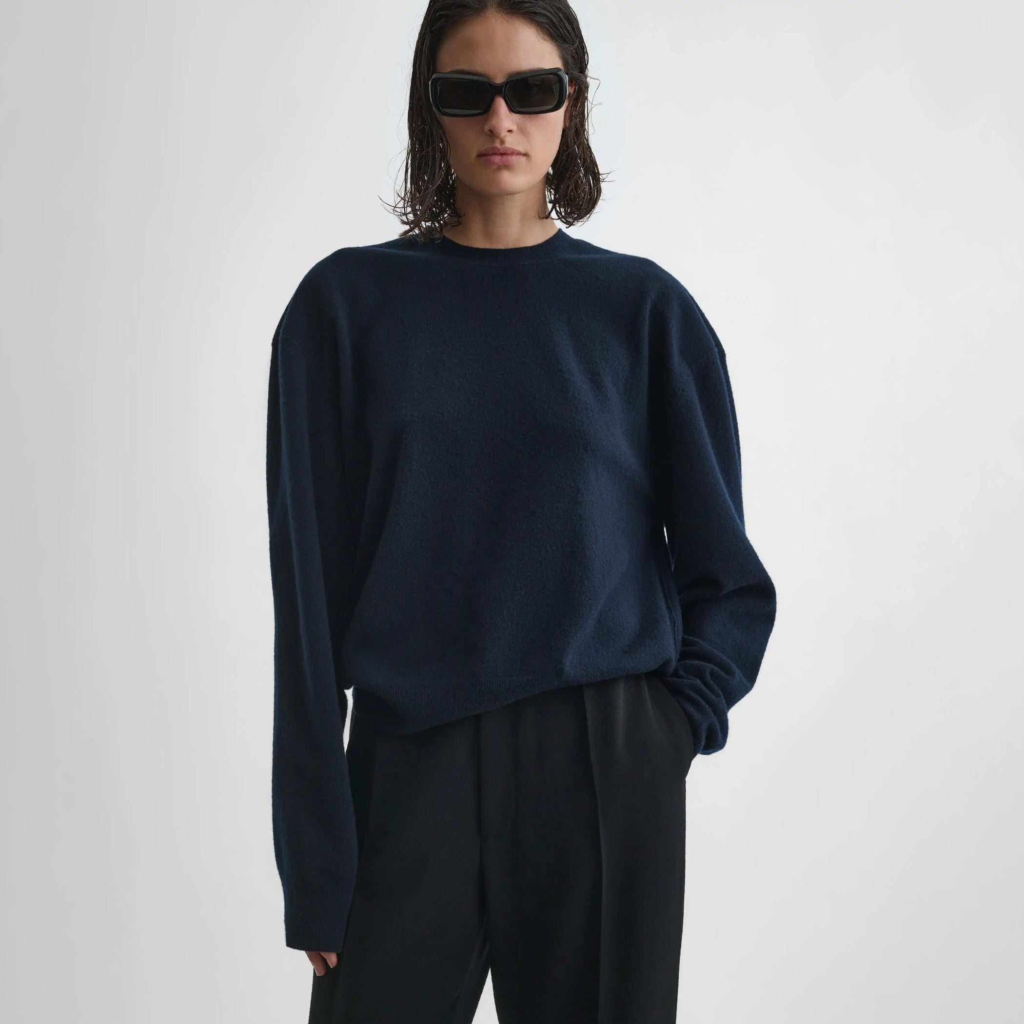 Front view of model wearing dropped shoulder jumper in navy