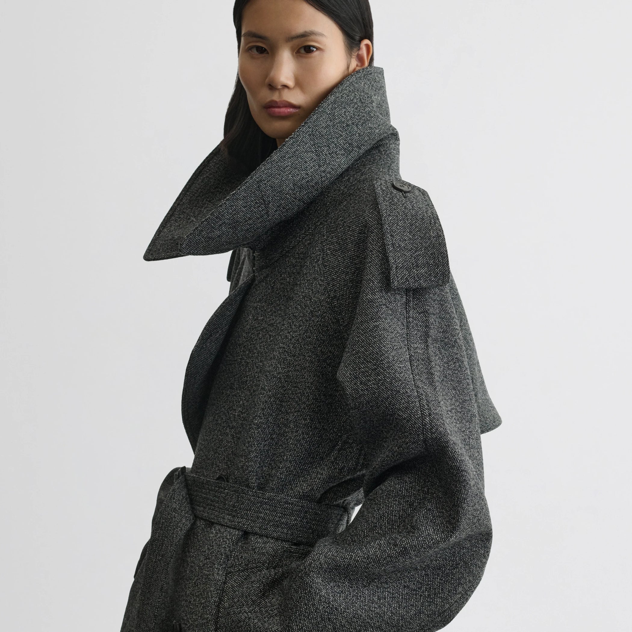 Close up detail view of padded trench coat in salt and pepper wool.