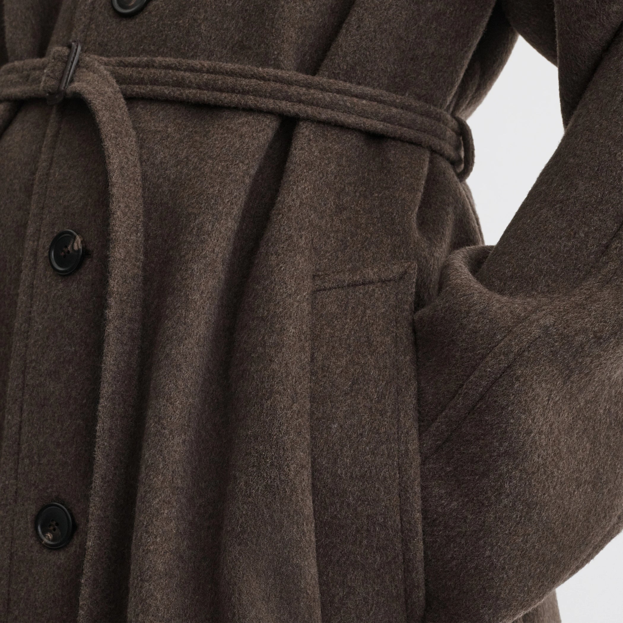 Close up detail view of curve shoulder coat in brown cashmere.