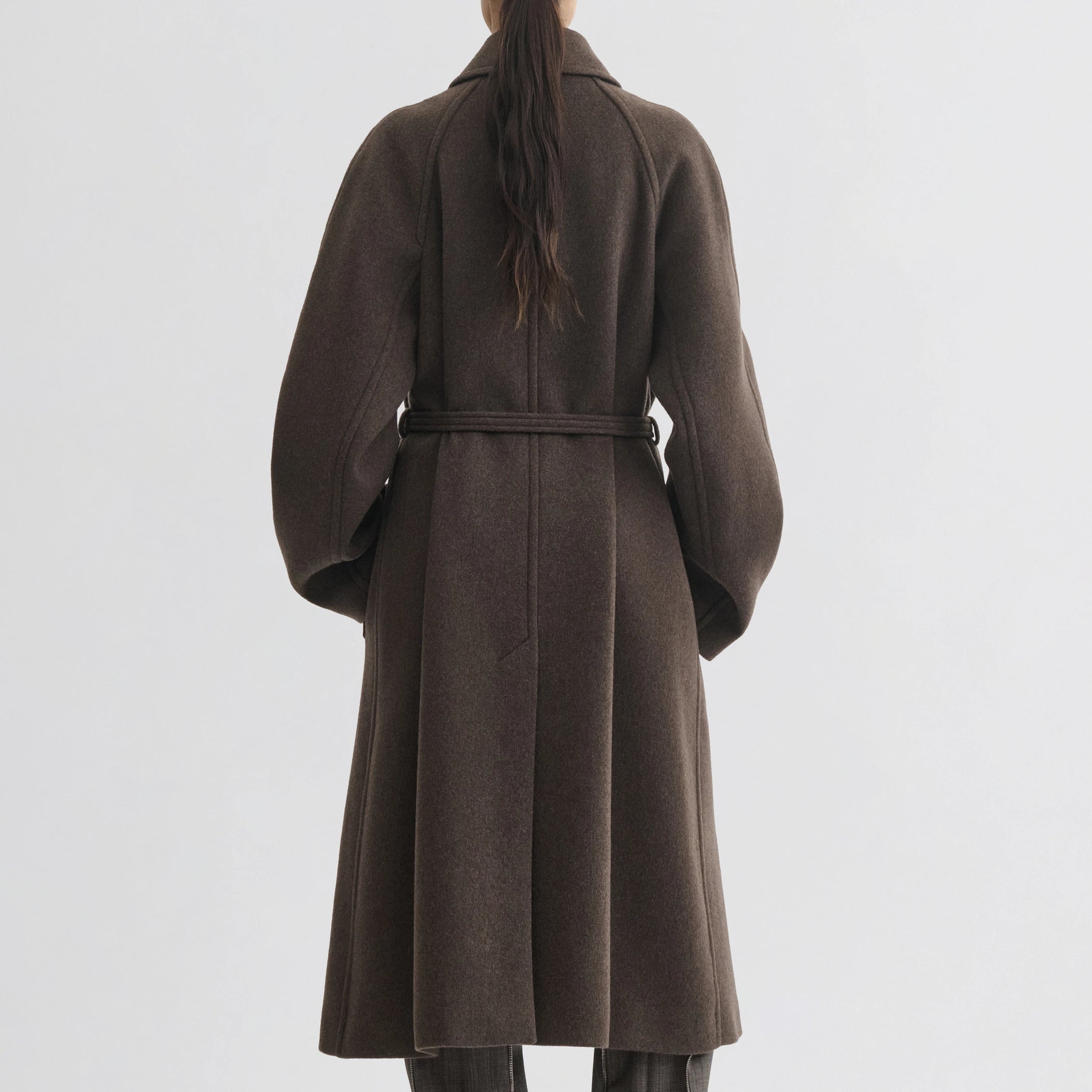 Back view of model wearing curve shoulder coat in brown cashmere.