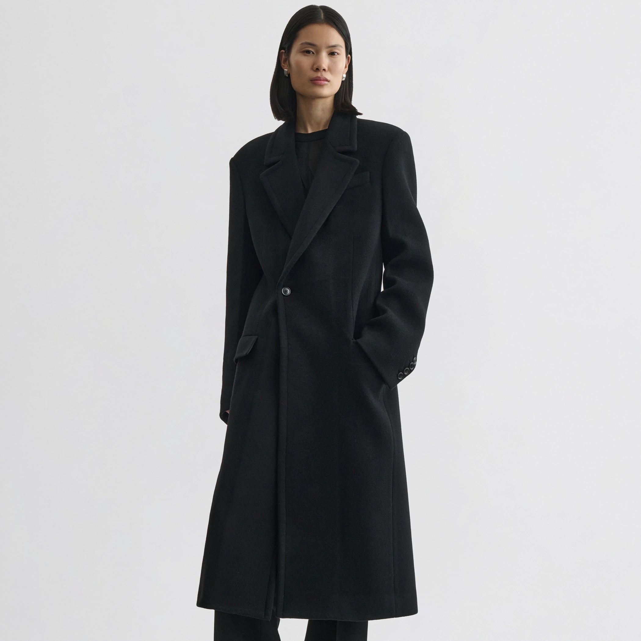 Front view of model wearing classic coat in black cashmere.
