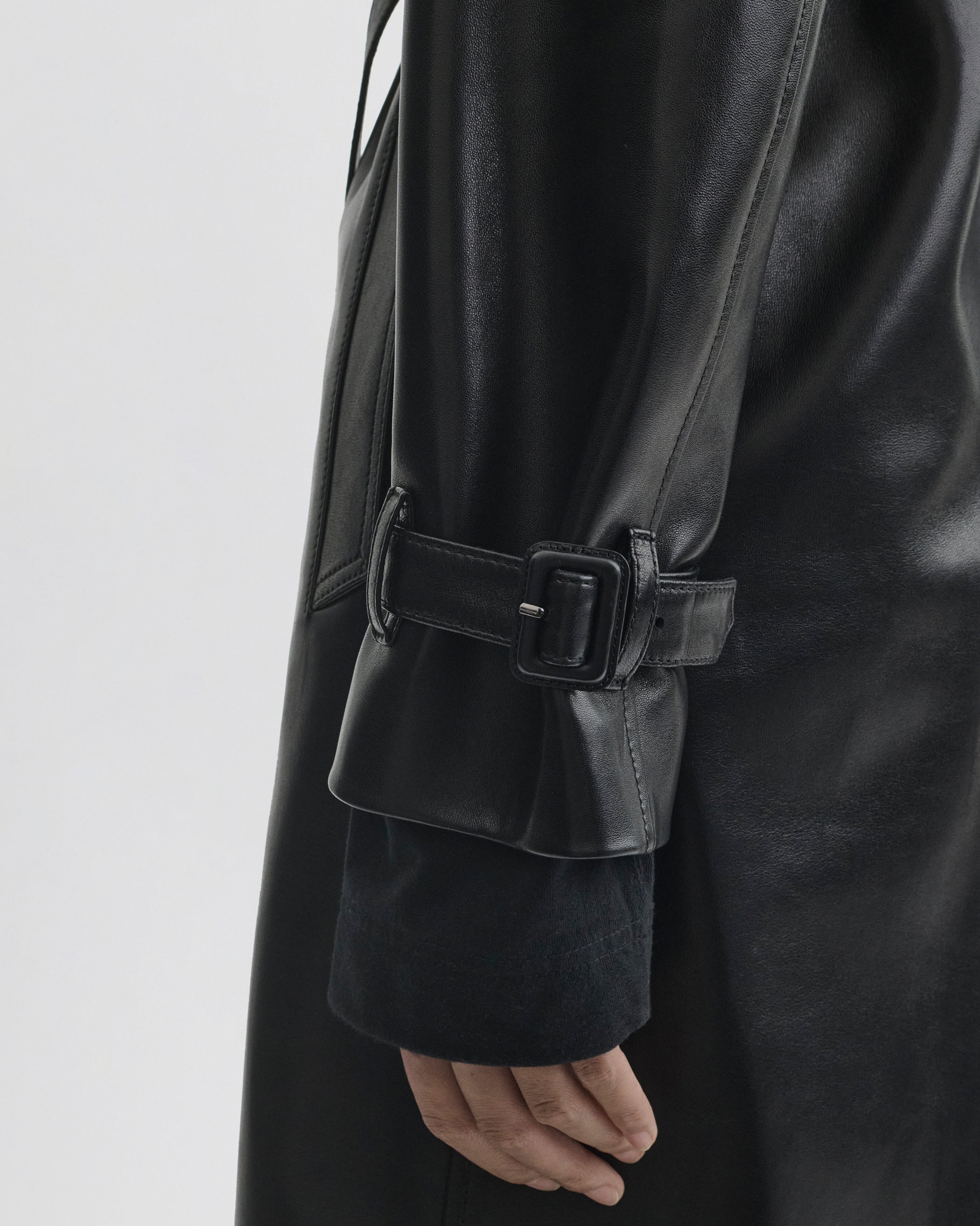 Close up detail view of Short Trench in black leather