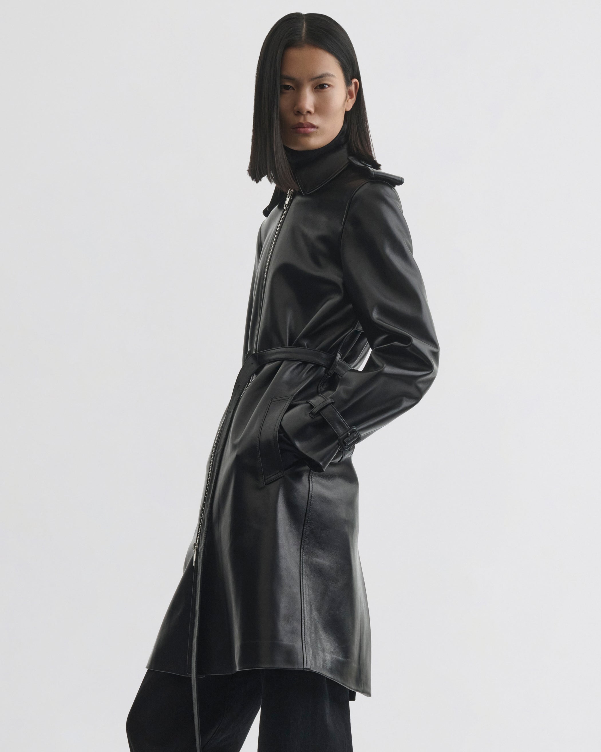 Side view of model wearing Short Trench in black leather
