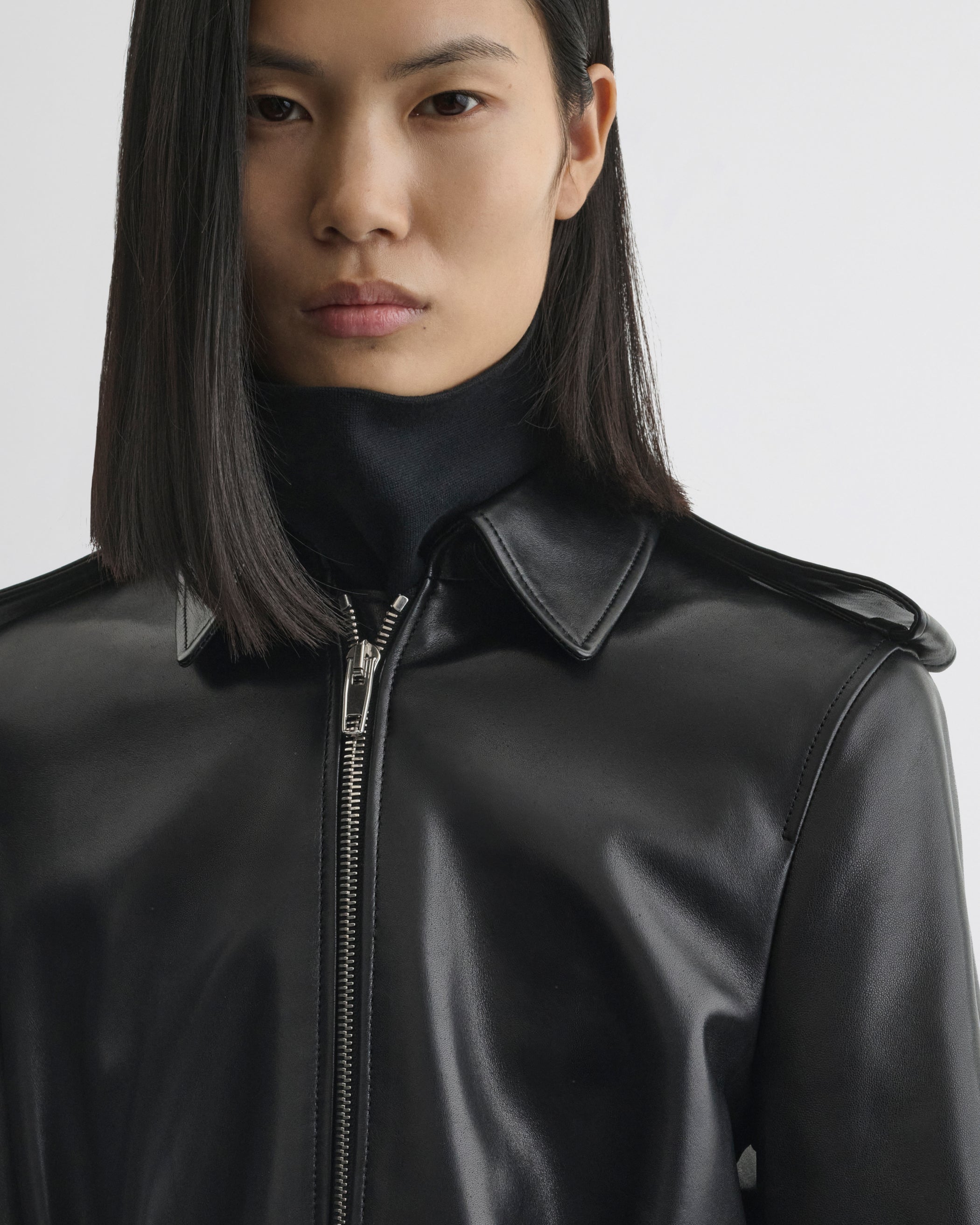 Close up detail view of Short Trench in black leather