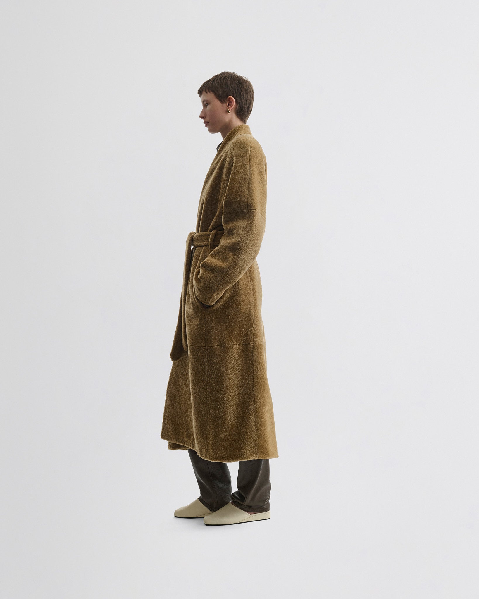 Side view of model wearing Shaved Robe Coat in tabac shearling