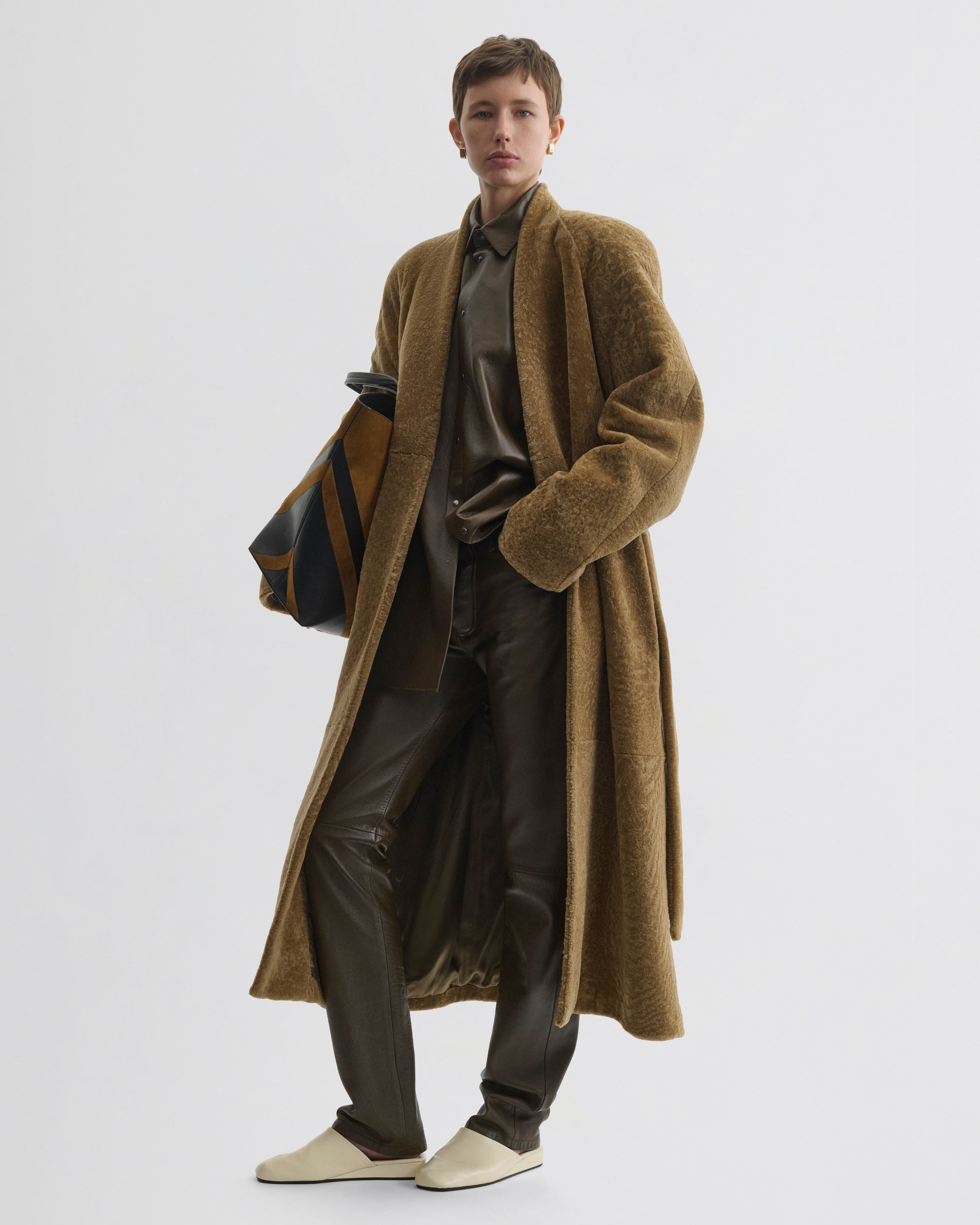 Front view of model wearing Shaved Robe Coat in tabac shearling