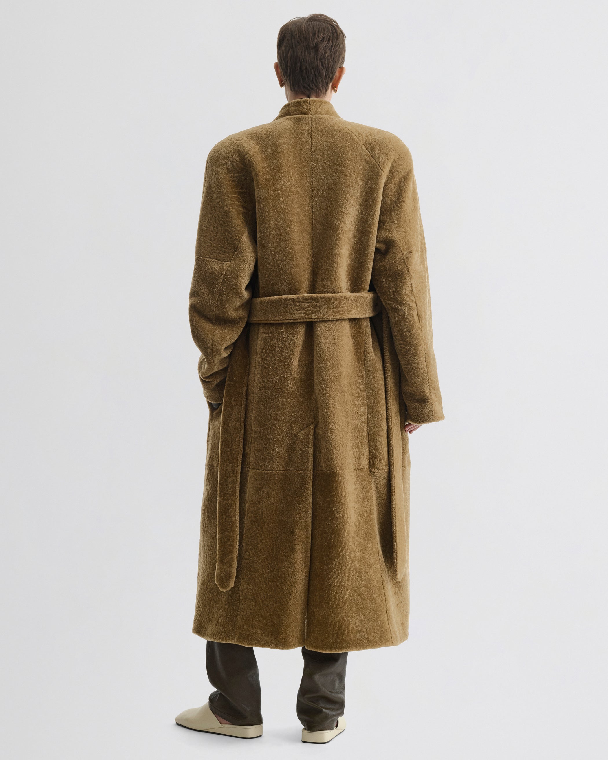 Back view of model wearing Shaved Robe Coat in tabac shearling